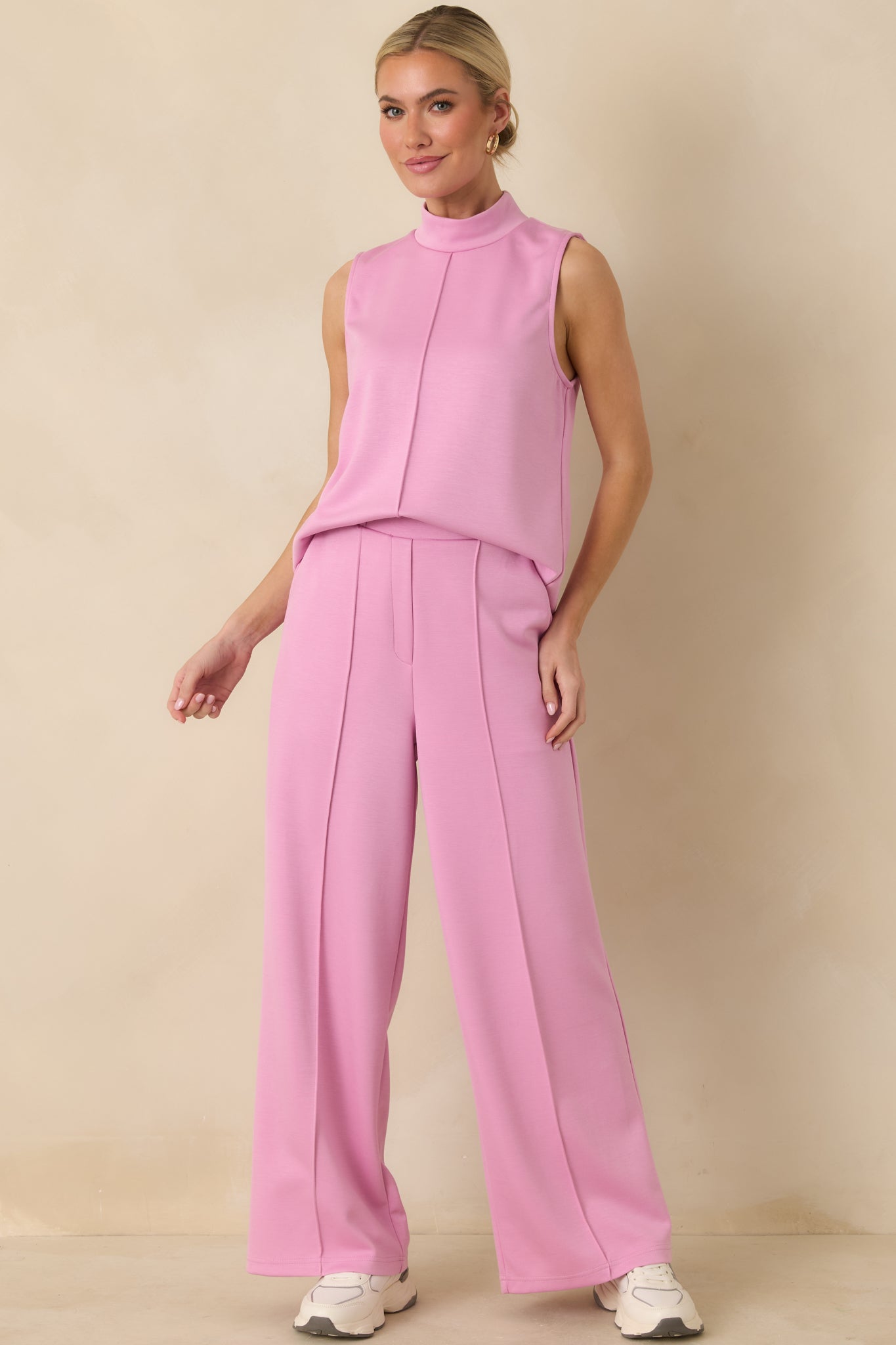 Pink knit pants designed with a tailored wide leg, clean hems, and a smooth drape that holds its shape.