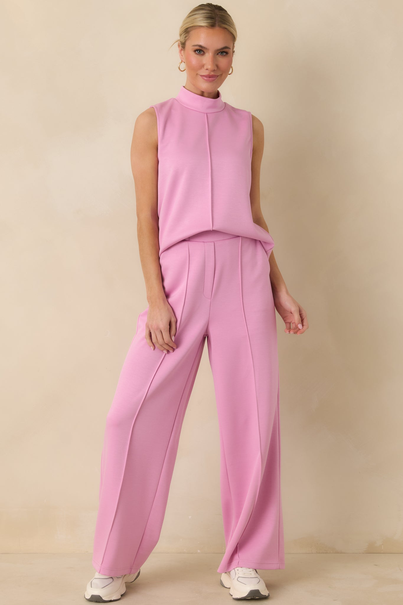 Pink sleeveless tank top with a relaxed straight silhouette, soft mock neckline, and smooth, clean finish.