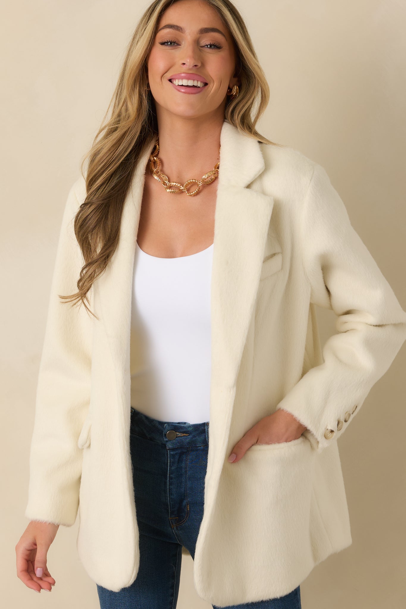 Cropped view highlighting long sleeves and relaxed tailoring of felted blazer.