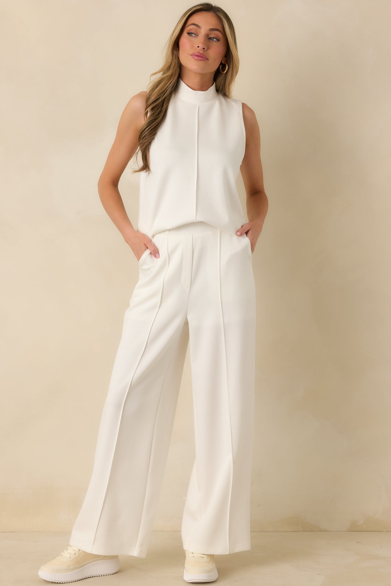 White knit wide-leg pants designed with a structured waistband and soft fabrication that holds its shape.