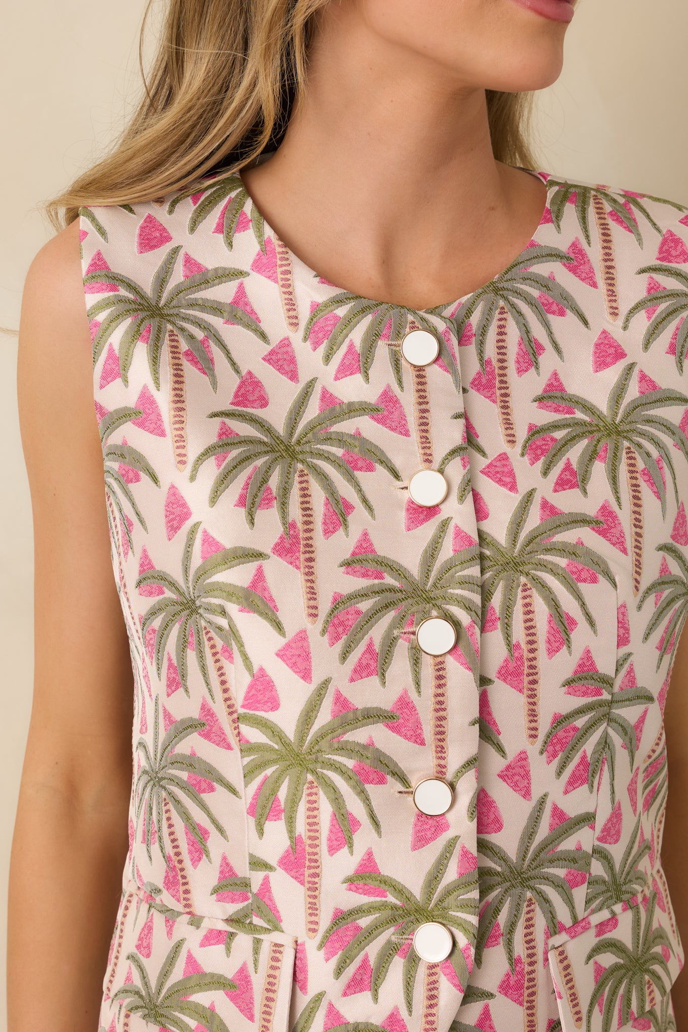 Close-up of the tonal pink palm jacquard top showing the white buttons with gold trim and fabric texture.