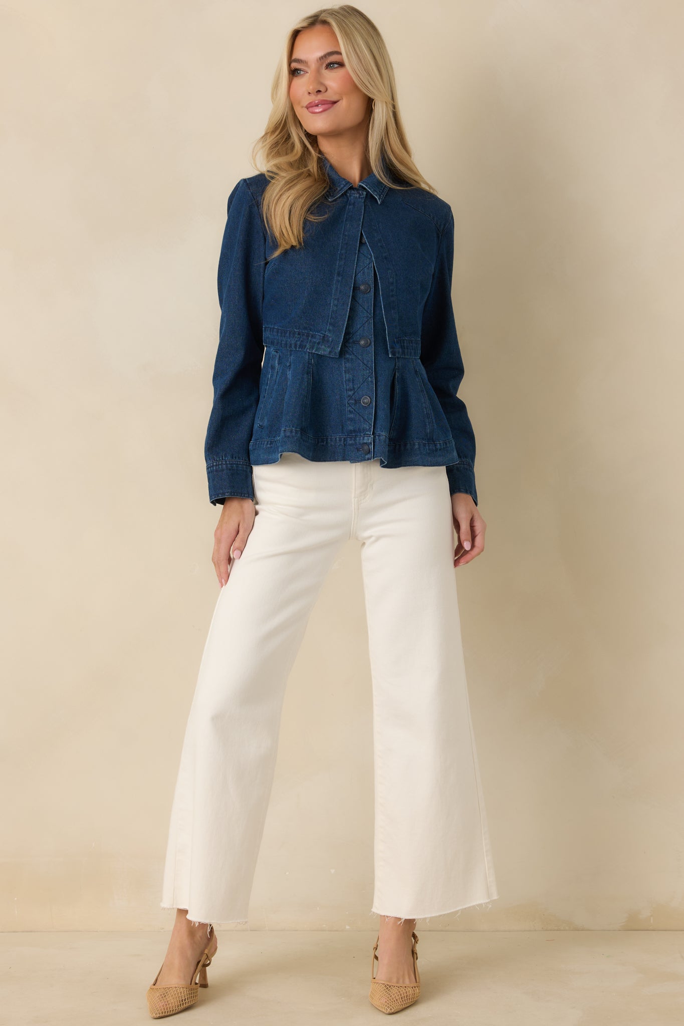 Cropped dark wash denim jacket with long sleeves, button cuffs, and classic collar detailing for a clean, structured look.