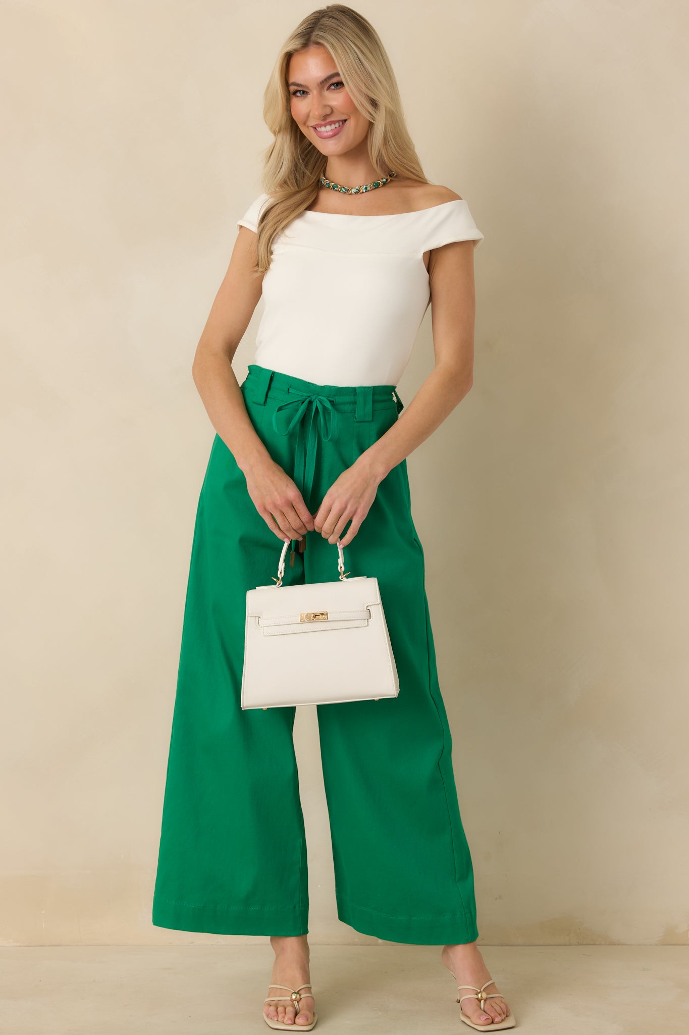 Ivory off-shoulder top designed with stretchy fabric for a comfortable, streamlined look.