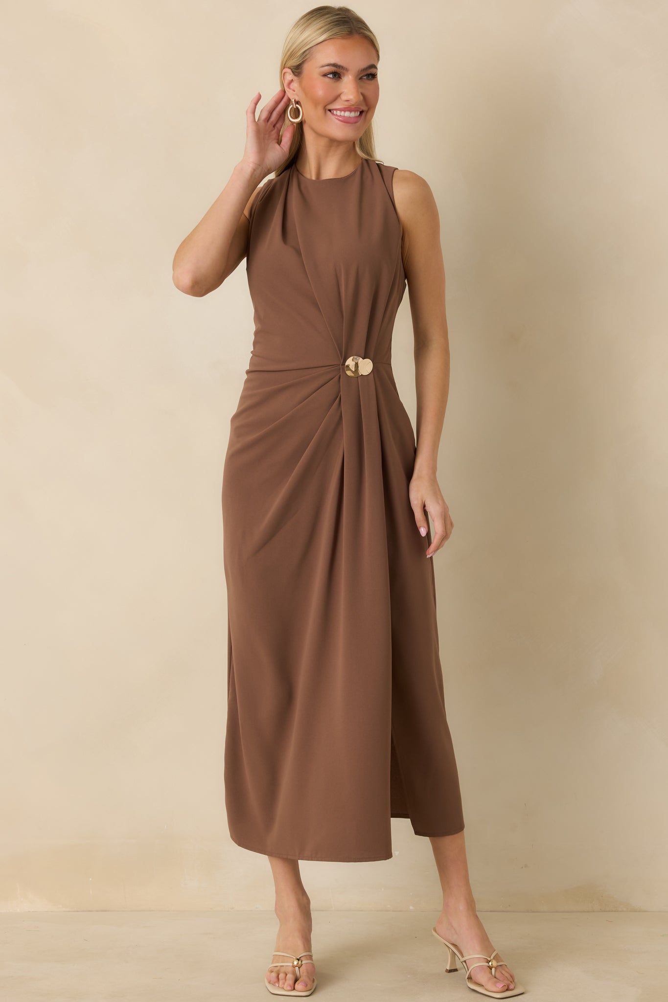 Light brown fitted dress with sleeveless cut, classic round neckline, and gathered detailing at the front.