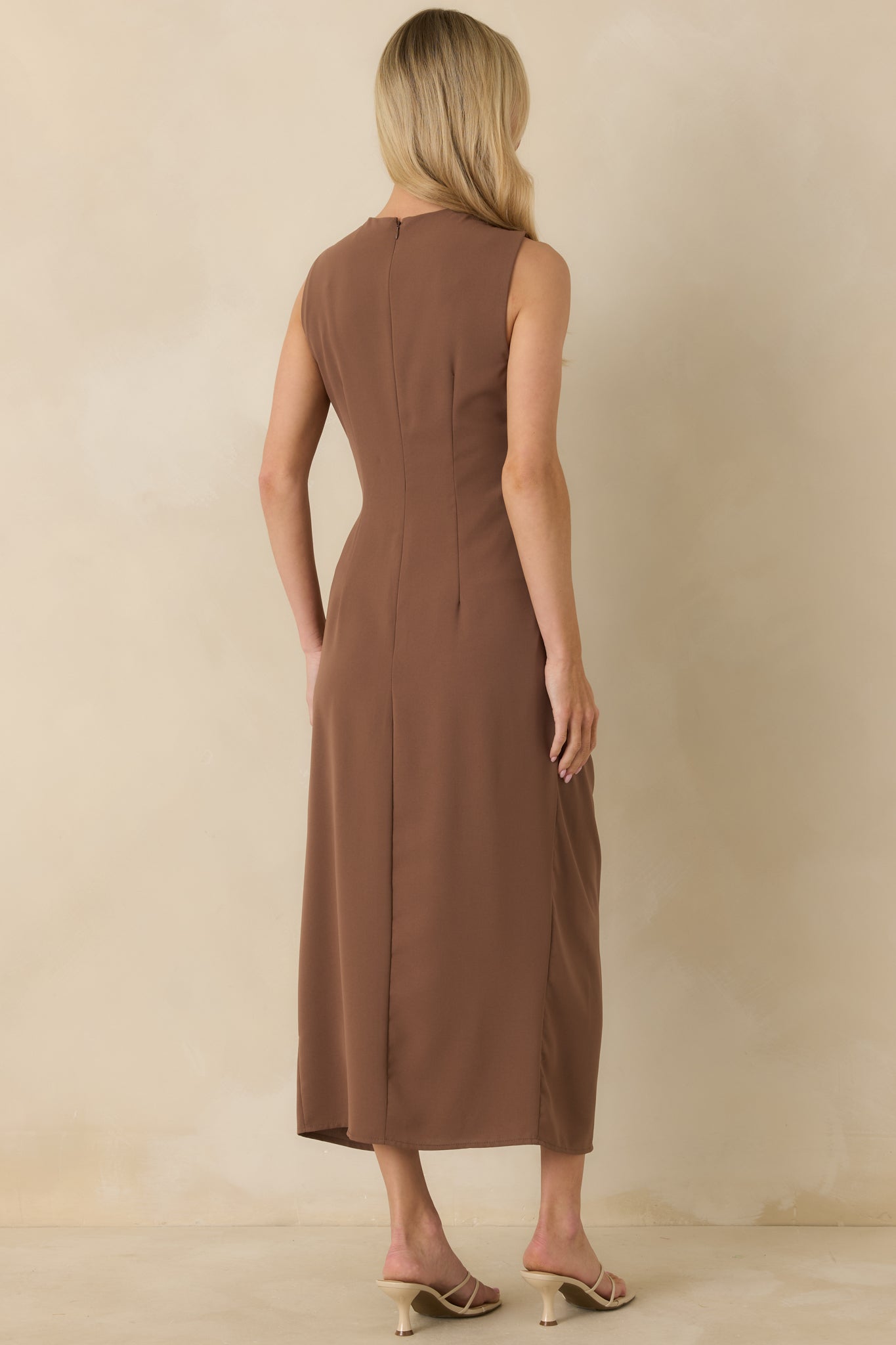 Back view of light brown sleeveless dress featuring clean lines and smooth, unruched finish.