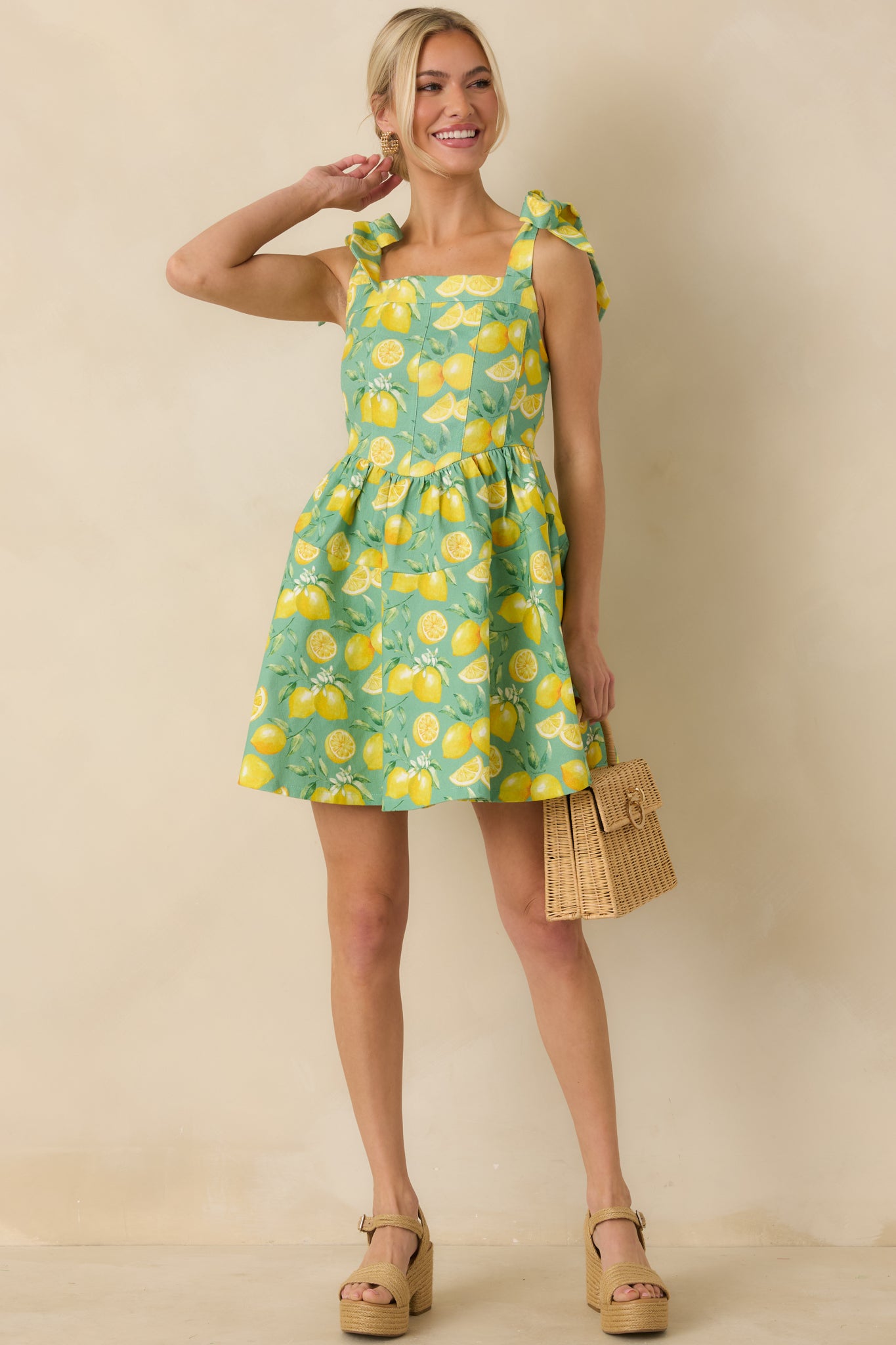 Three-quarter front angle emphasizing the adjustable self-tie bow straps and fitted bodice.