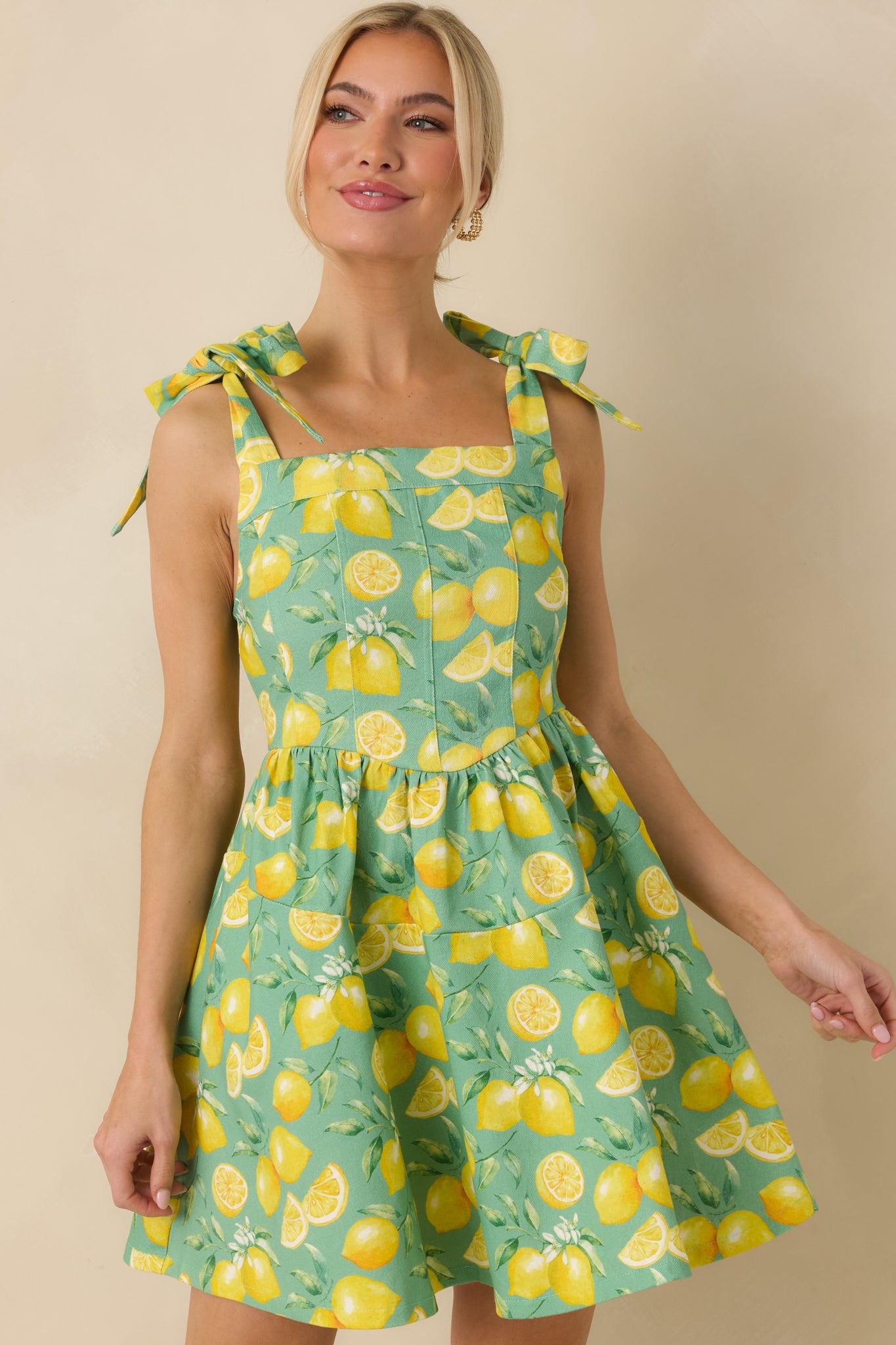 Cropped view focusing on the square neckline and smocked back panel detail.