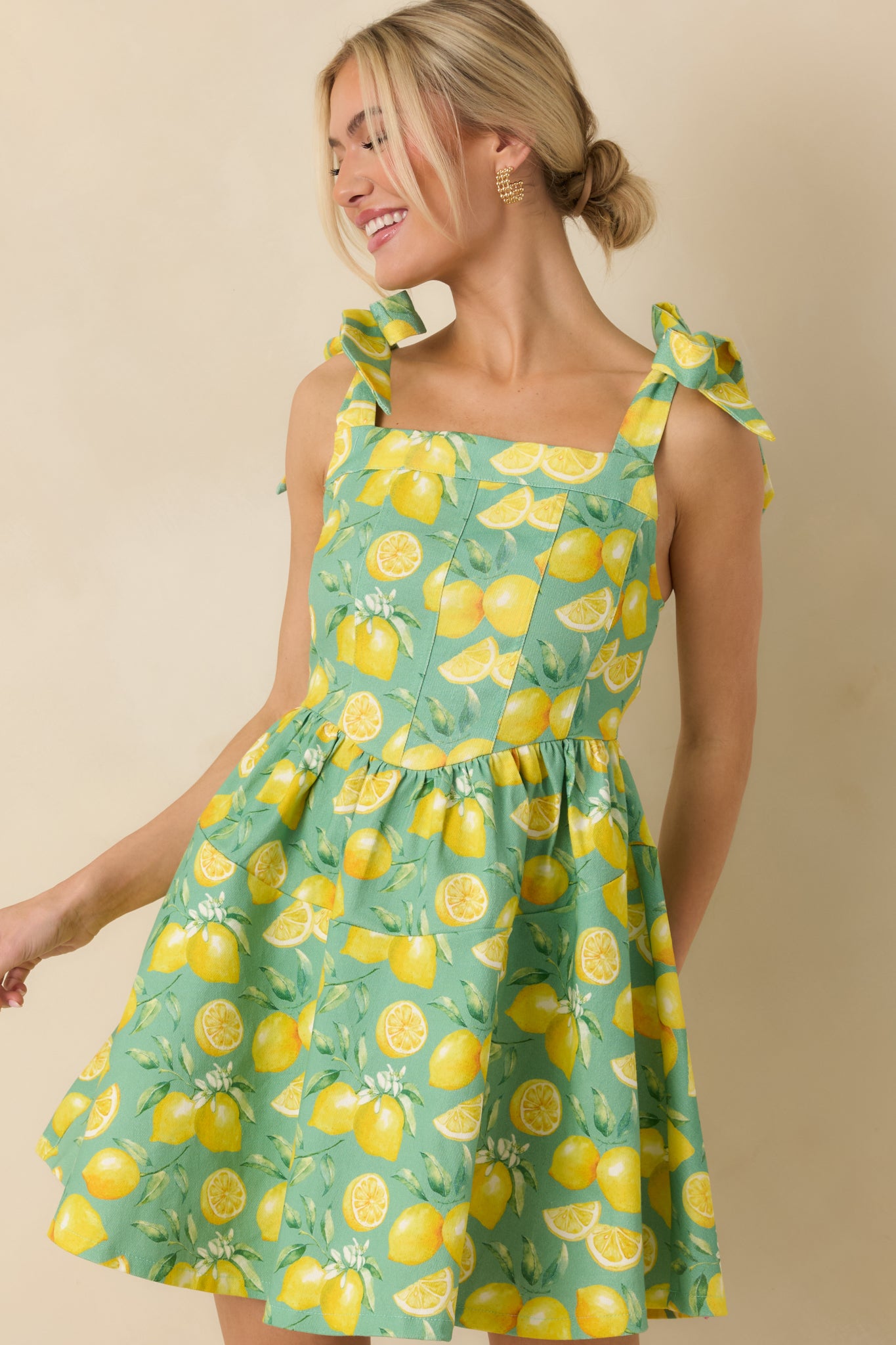 Close crop highlighting the adjustable bow straps and paneled bodice design.