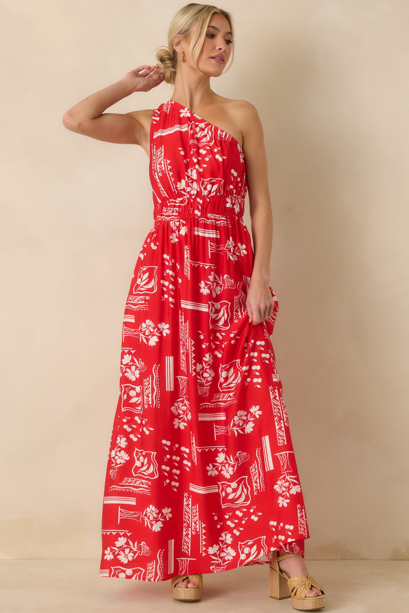 Front view of red maxi dress highlighting the white geometric floral print and elastic waist.