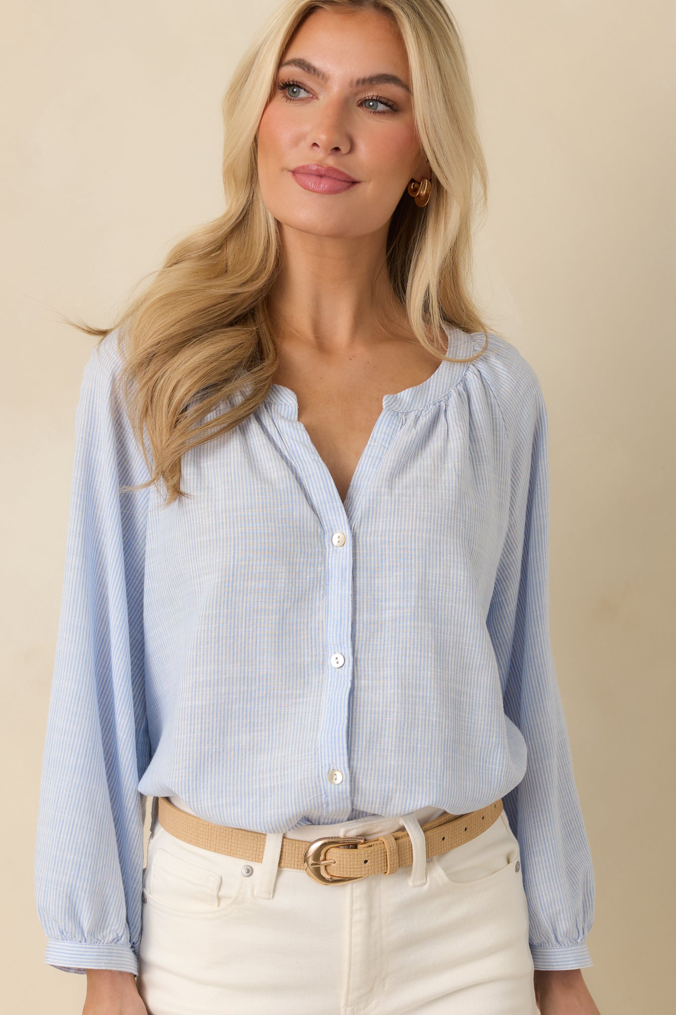 Cropped front view highlighting the split neckline and functional buttons of the lightweight blouse.