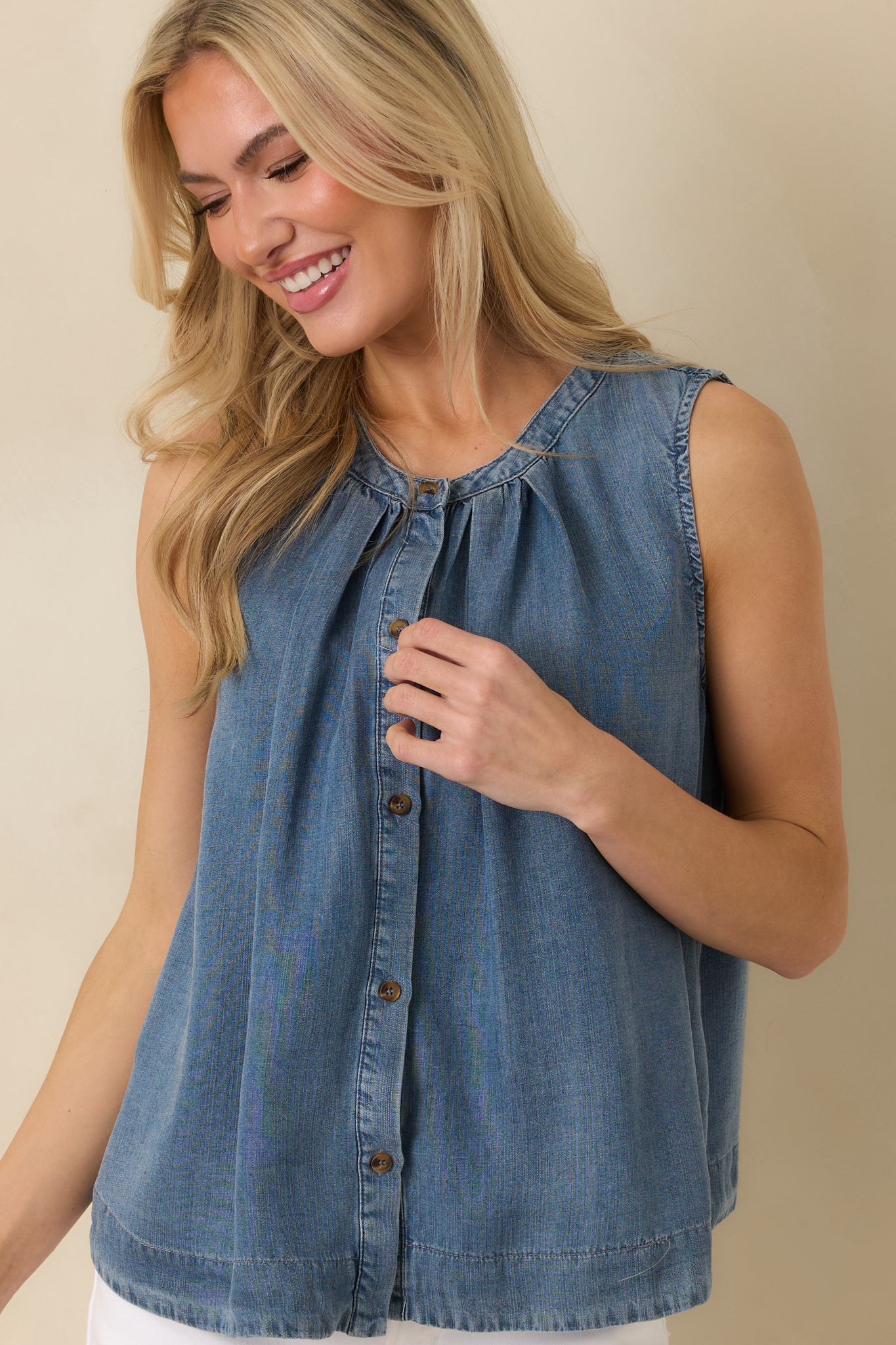 Cropped front view emphasizing the button-front closure and softly gathered neckline of the chambray top.