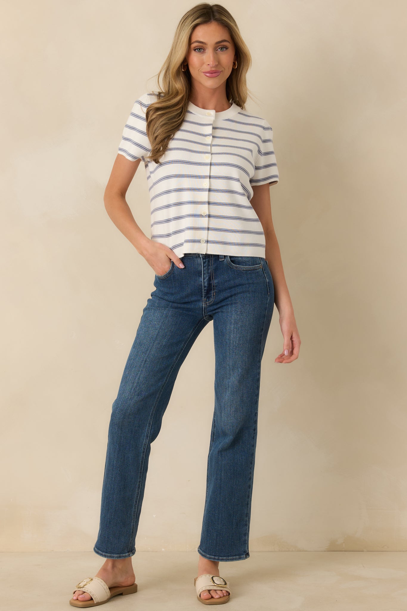 Lightweight ribbed knit top with horizontal navy stripes, crew neckline, short sleeves, and full button-front closure for versatile styling.