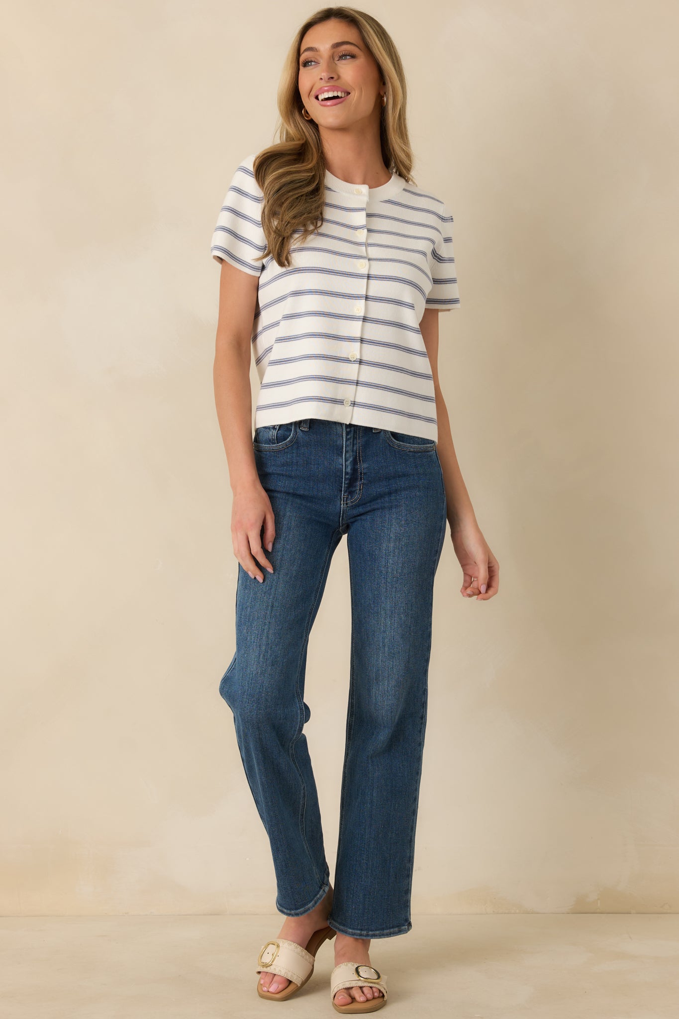 Soft ribbed top with short sleeves, horizontal stripes, and a fully buttoned front creating a clean, everyday coastal-inspired look.