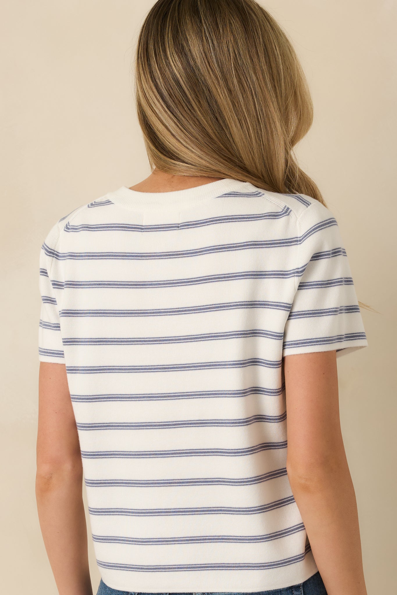 Rear view of the navy striped ribbed top displaying short sleeves, smooth knit texture, and horizontal stripe pattern.