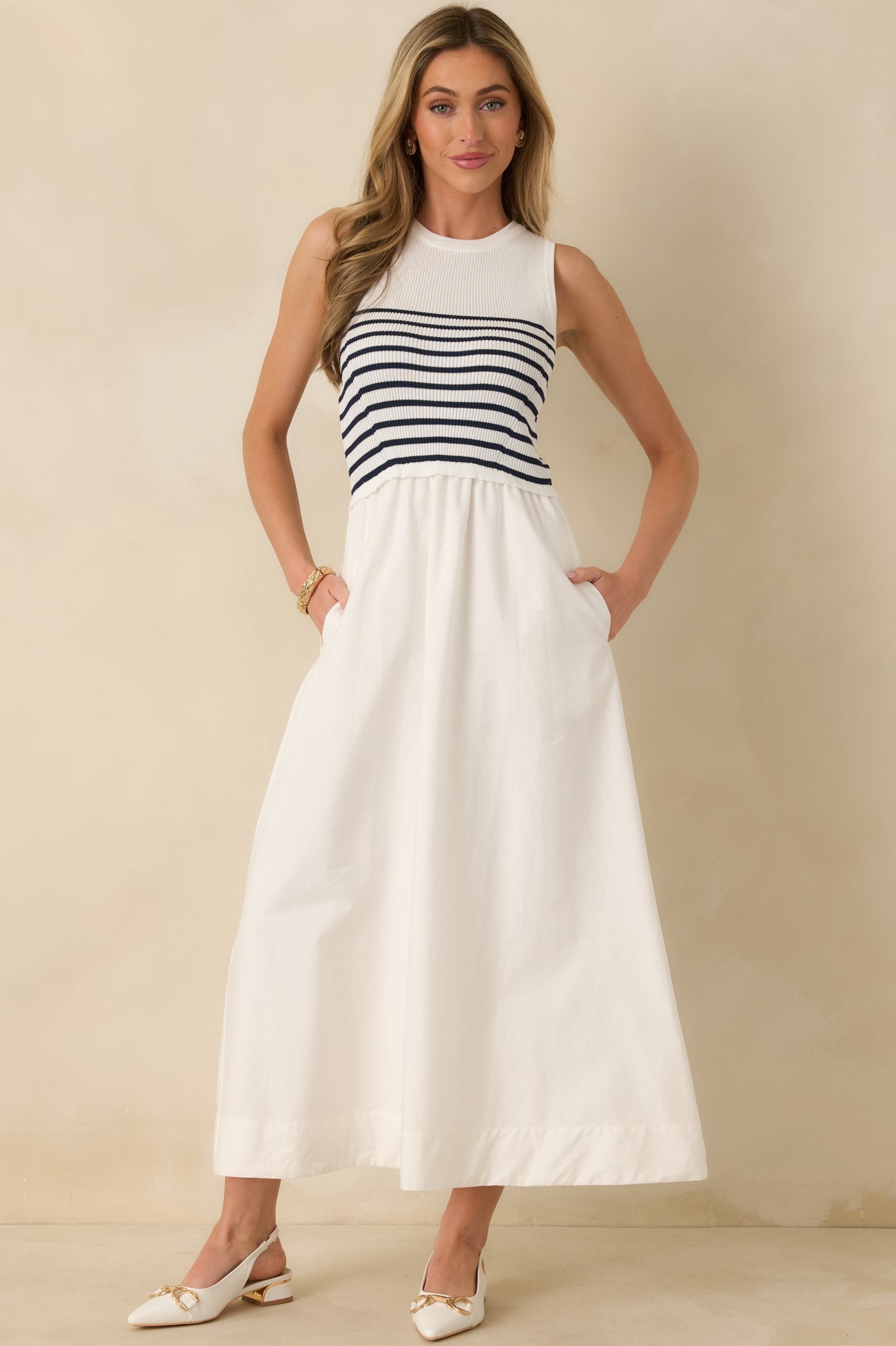 White stripe dress with fitted bodice, round neckline, and two functional side pockets for ease of wear.