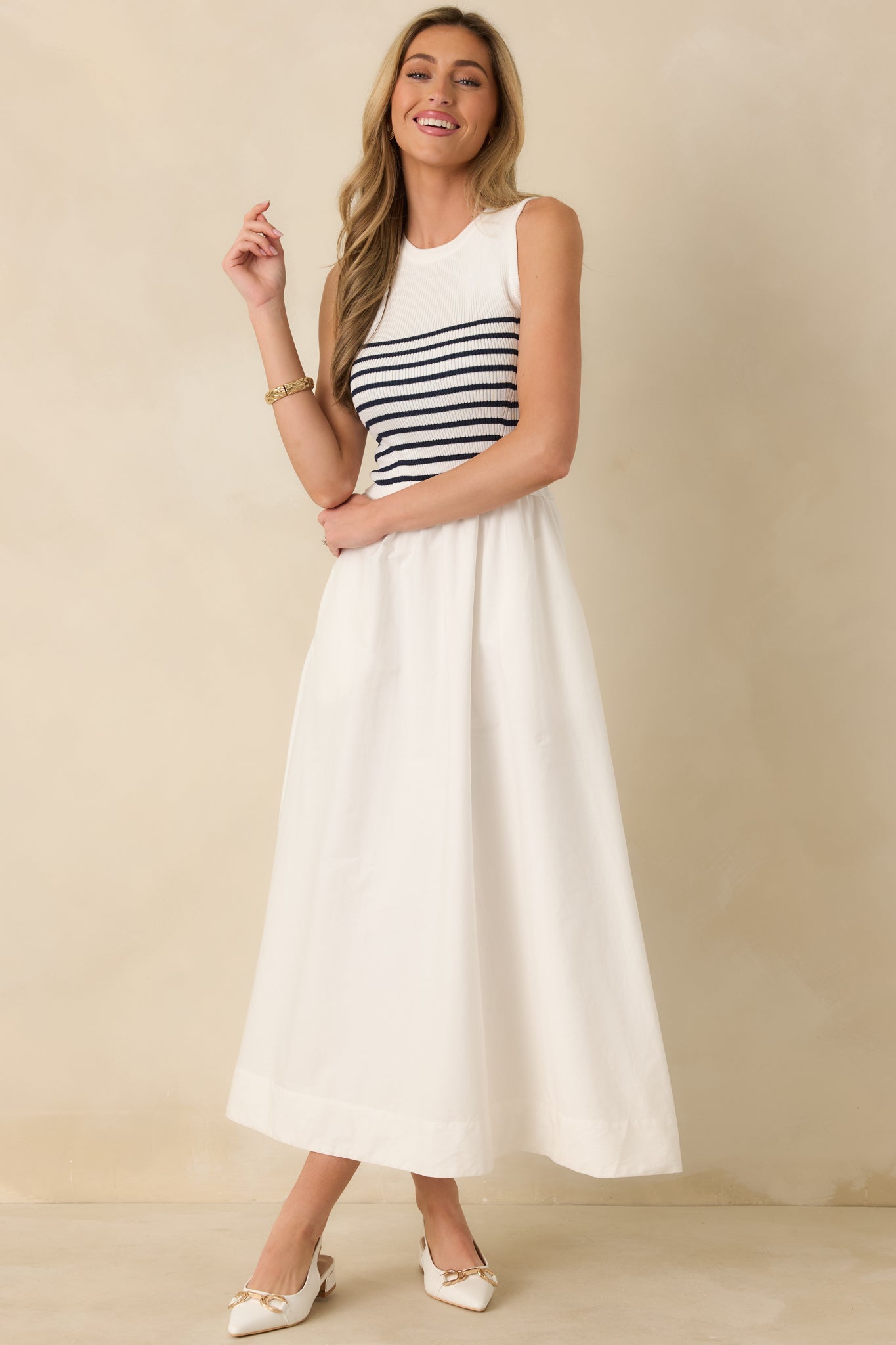 Fitted white striped dress featuring a classic round neckline and easy-access pockets.