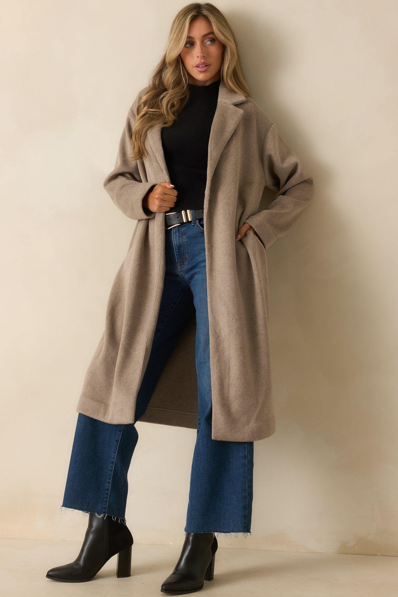 Full body front angle showing the notched lapels and single button closure in taupe fabric.