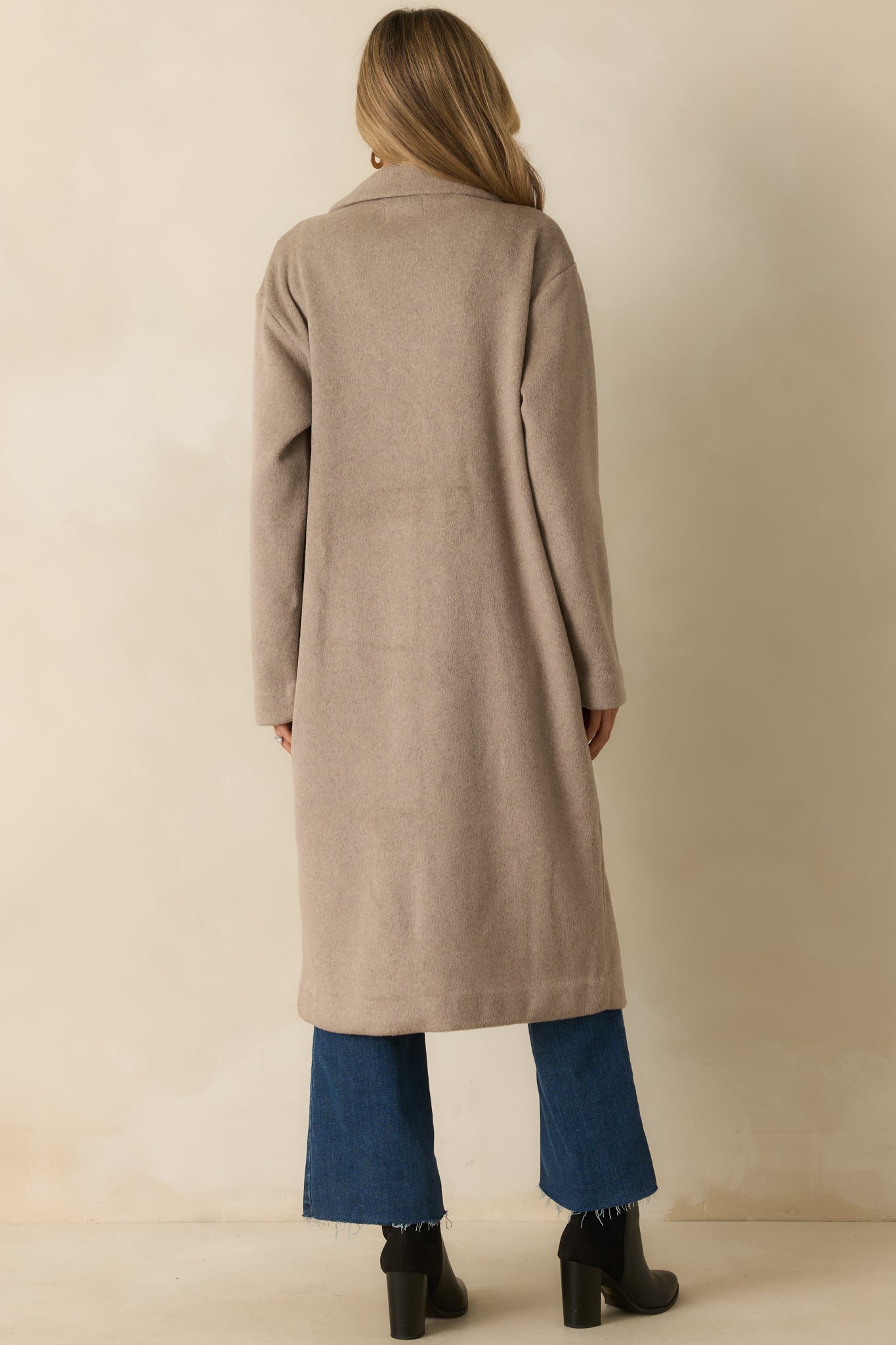 Back view of the coat showing the straight longline silhouette and clean taupe finish.