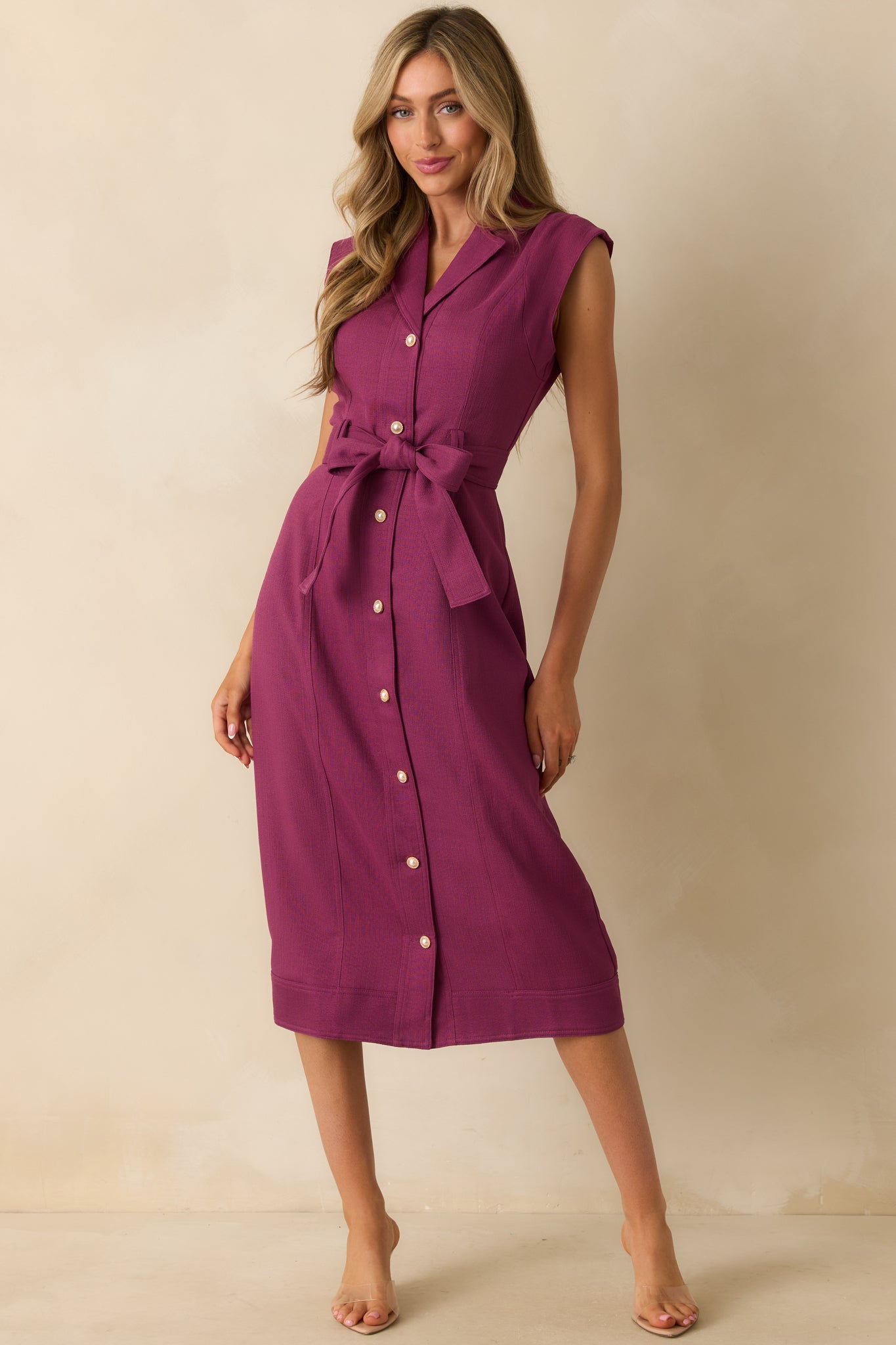 Deep plum midi dress highlighting the cap sleeves and structured collar detail.