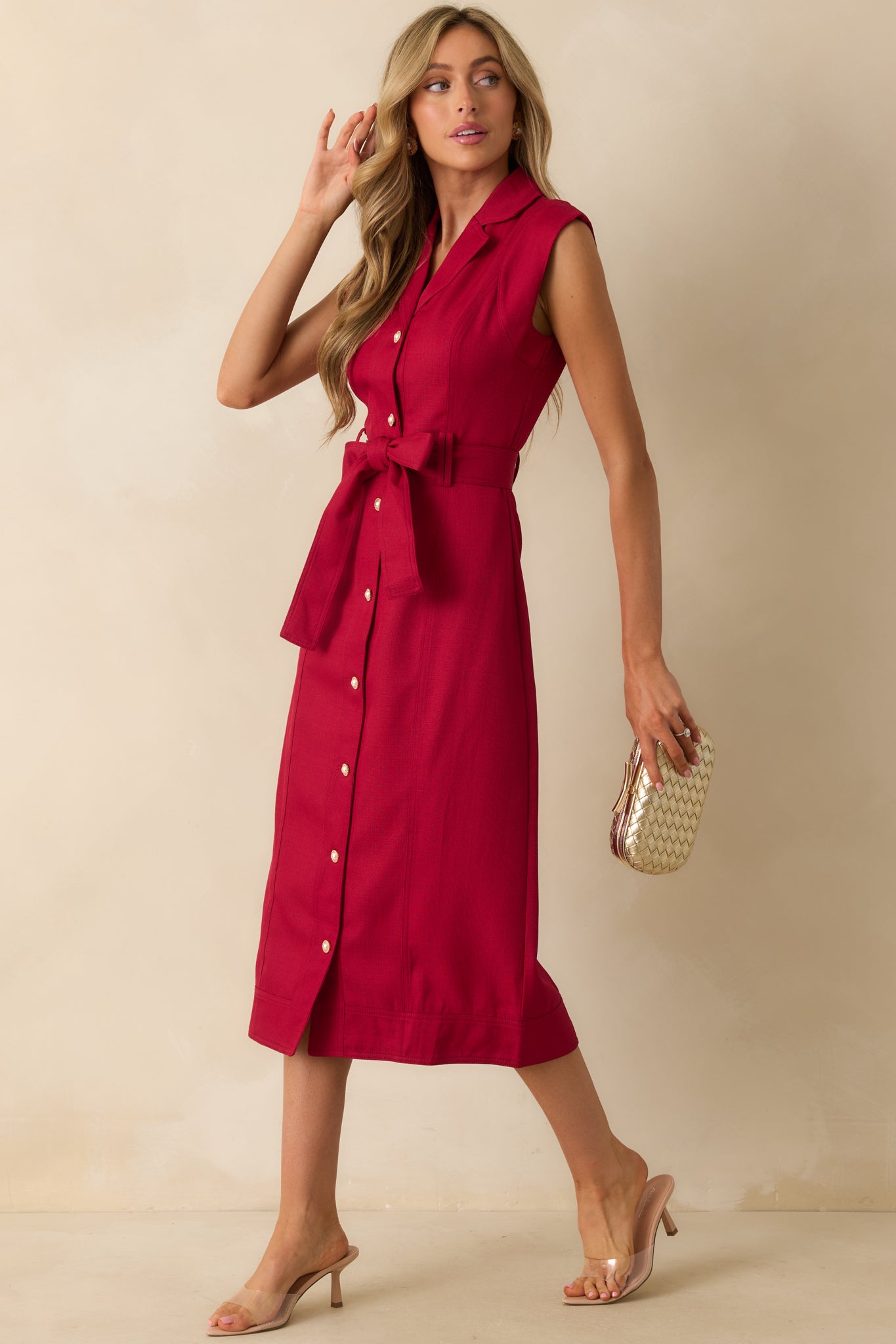 Red wine midi dress emphasizing the flowing silhouette and belted waist detail.