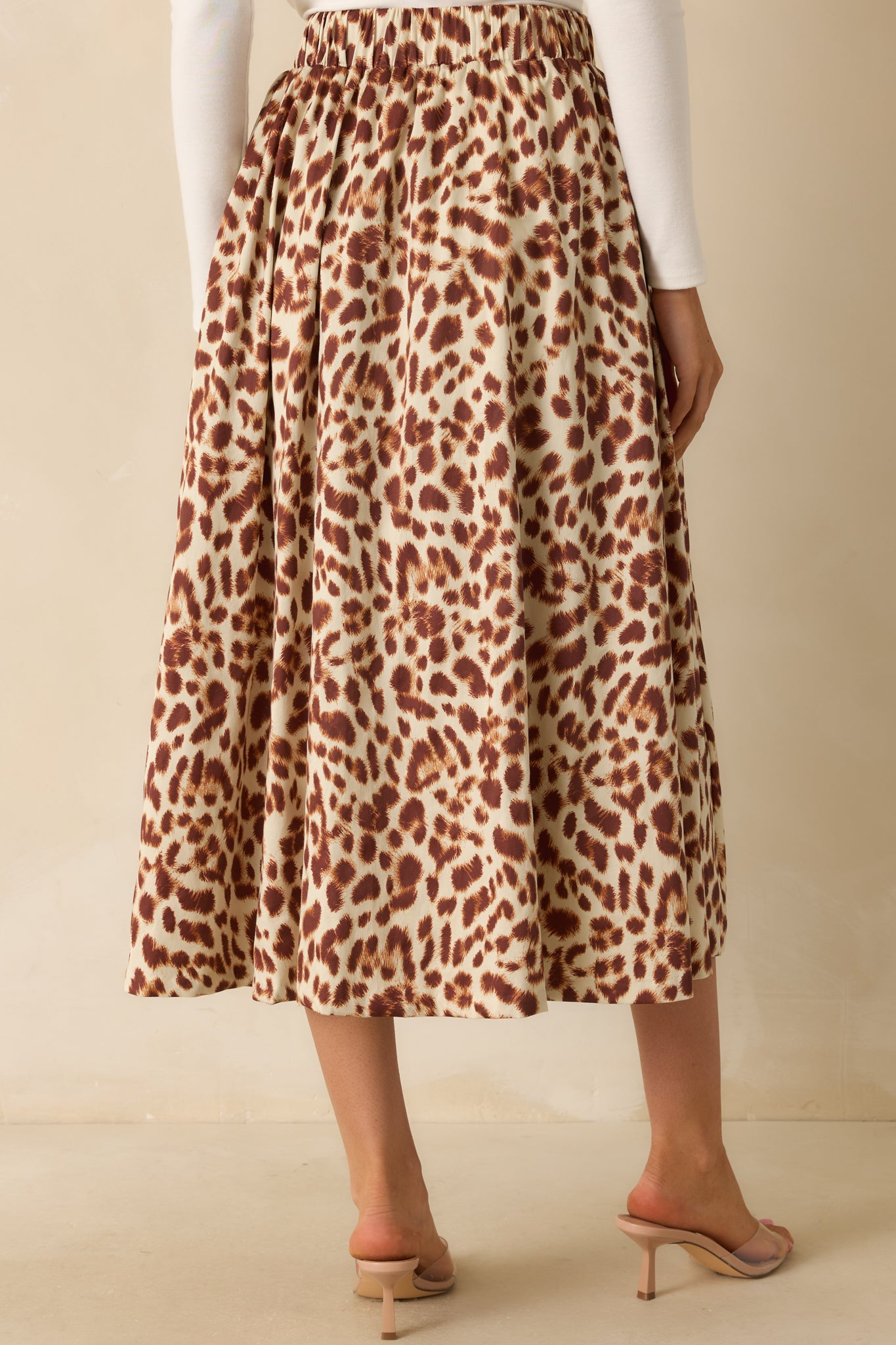 Rear view of the midi skirt showing the elastic back waist insert and straight hemline.