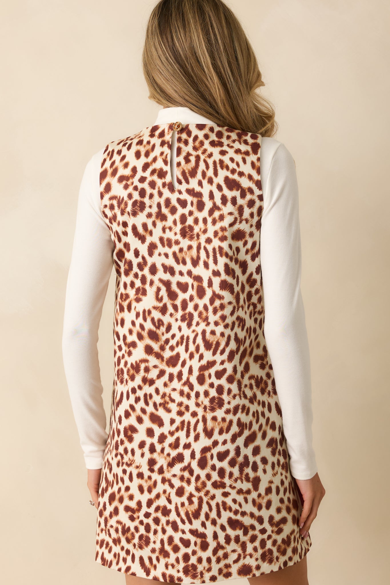 Rear view of the mini dress showing the keyhole closure and straight shift silhouette.