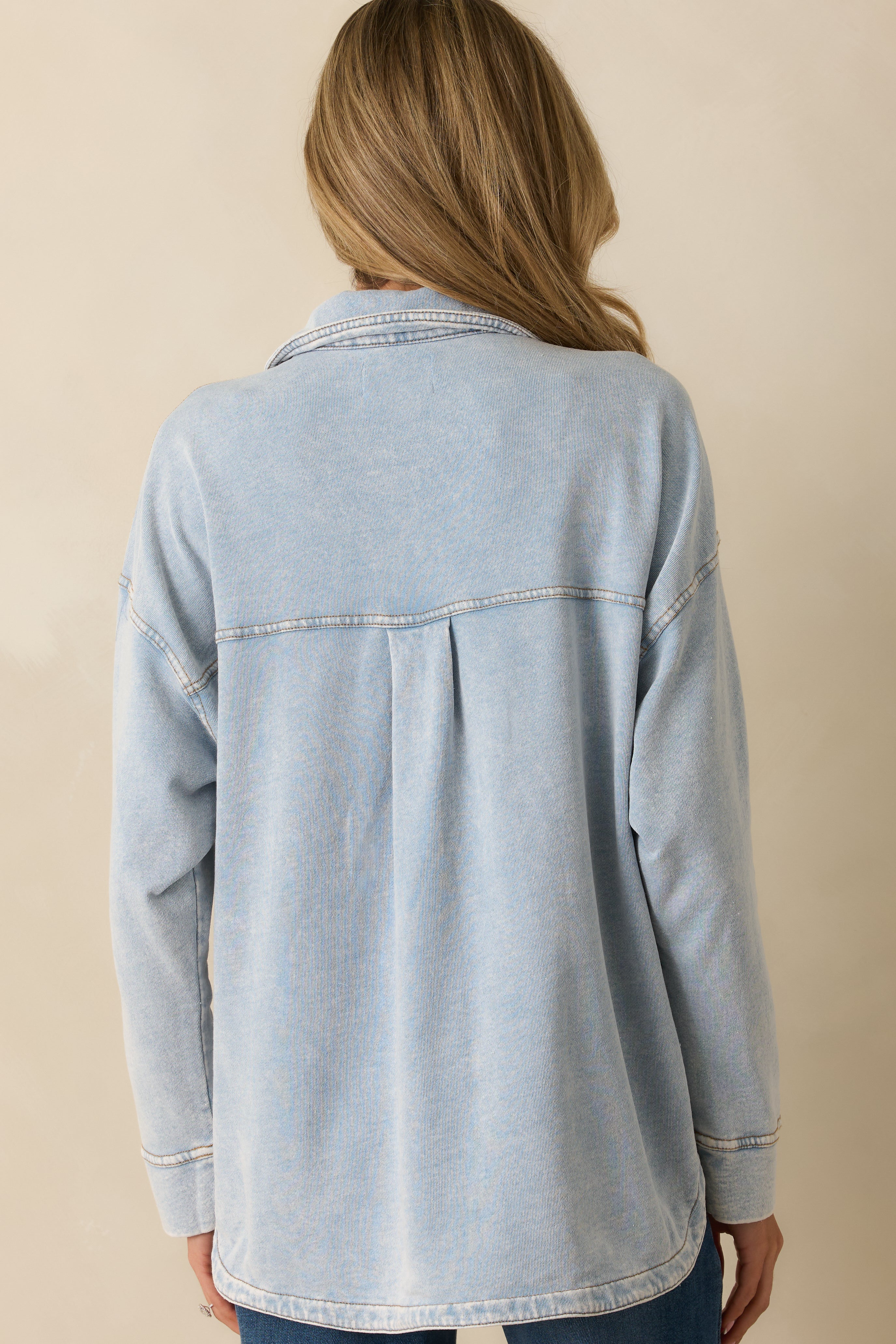 Rear view of the denim jacket showing the relaxed fit and smooth curved hemline.