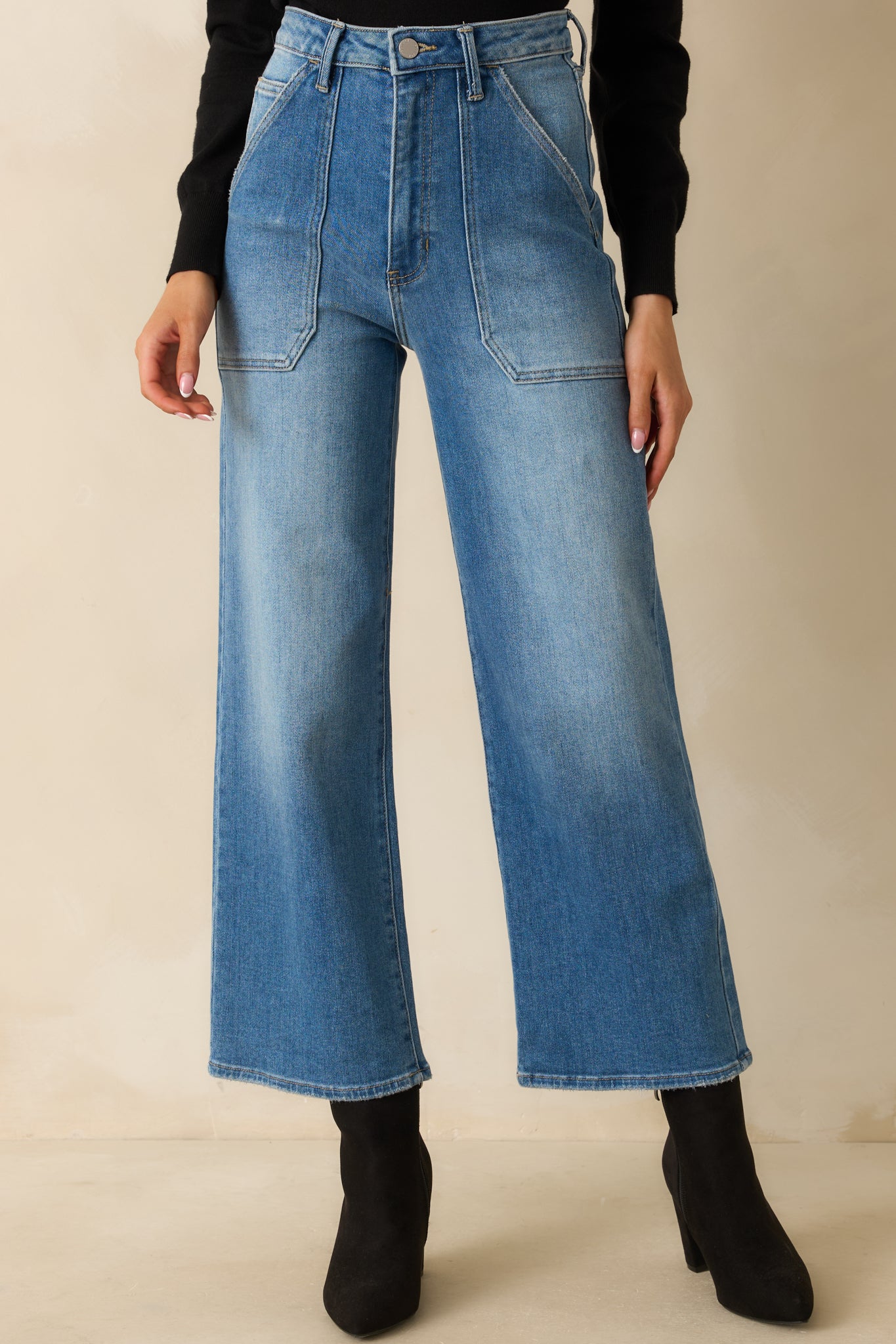 Close view of the front pockets, belt loops, and button-zipper closure.