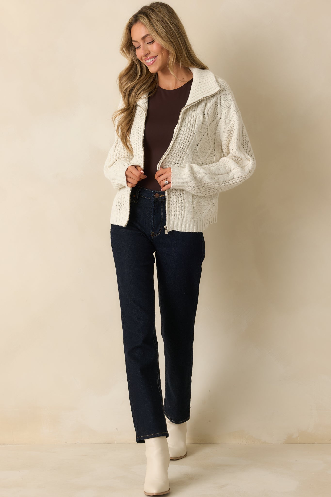 Angled front view highlighting the ribbed hem detailing and textured cable knit fabric.