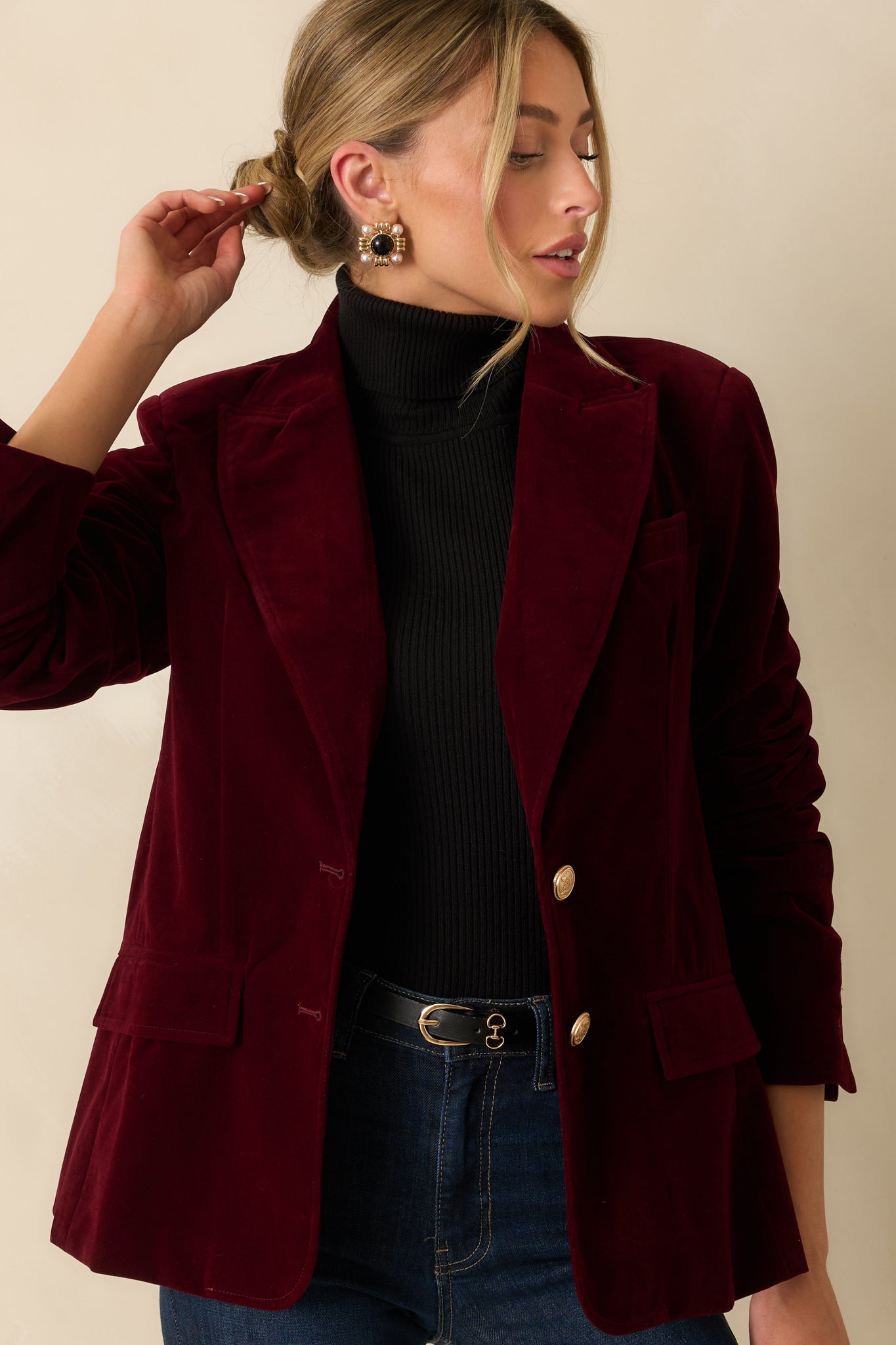 Front flap pockets and two-button closure emphasized in a cropped view of the blazer.