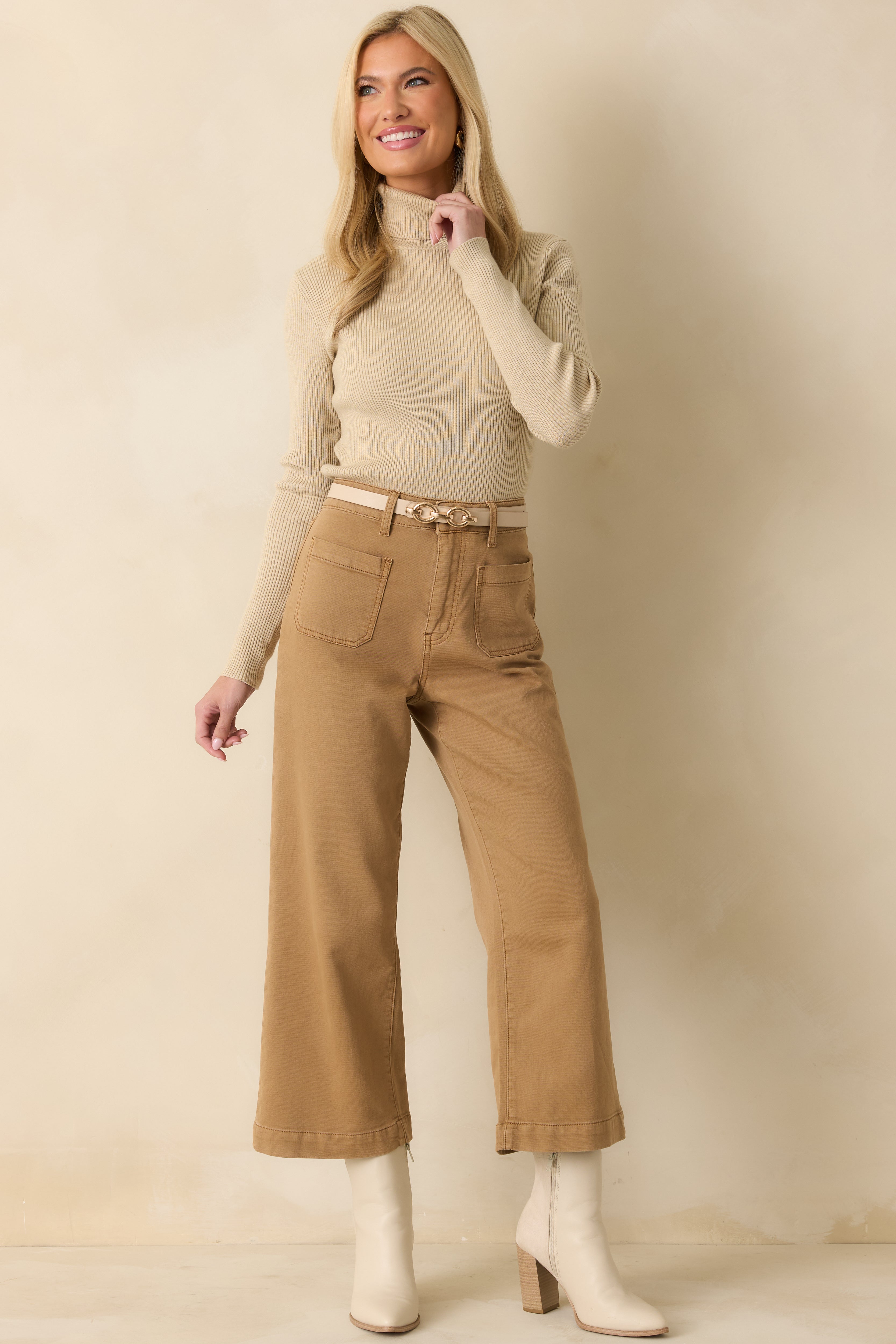 Front view of the khaki sweater showing the ribbed texture, turtleneck, and long sleeves.
