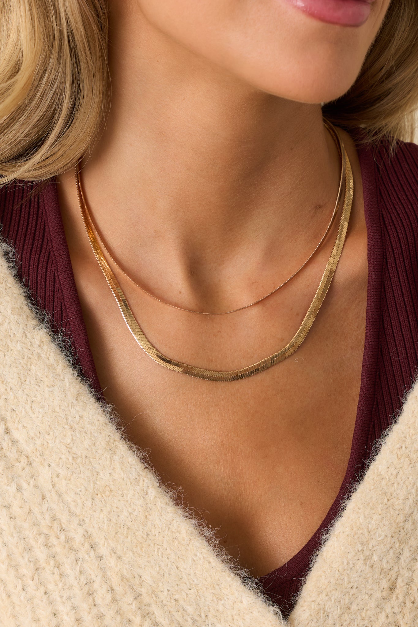 Gold double herringbone chain necklace featuring two layered chains in different widths shown from the front.