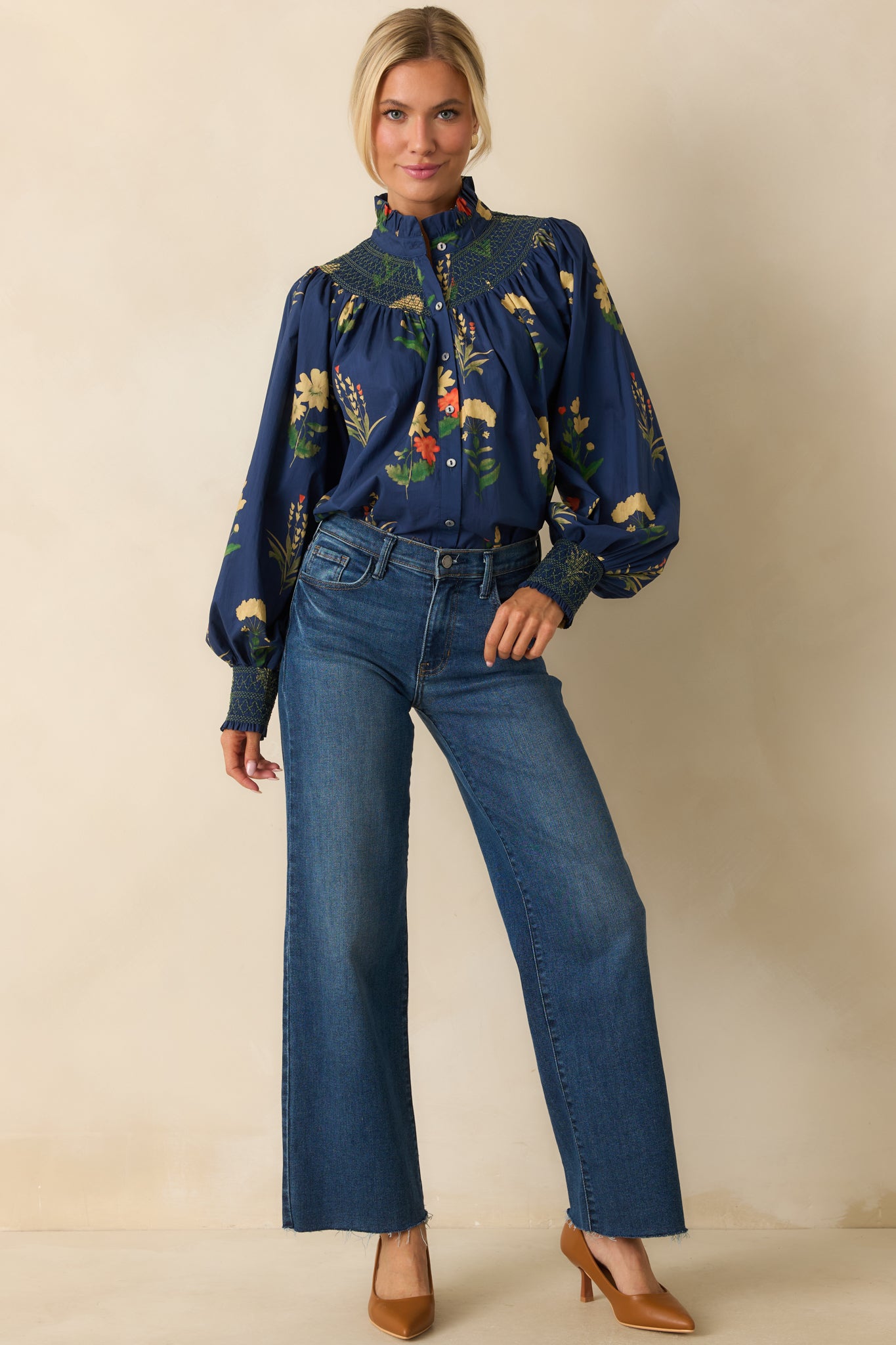 Long-sleeve blouse featuring bishop sleeves and a smocked yoke with contrasting green embroidery.