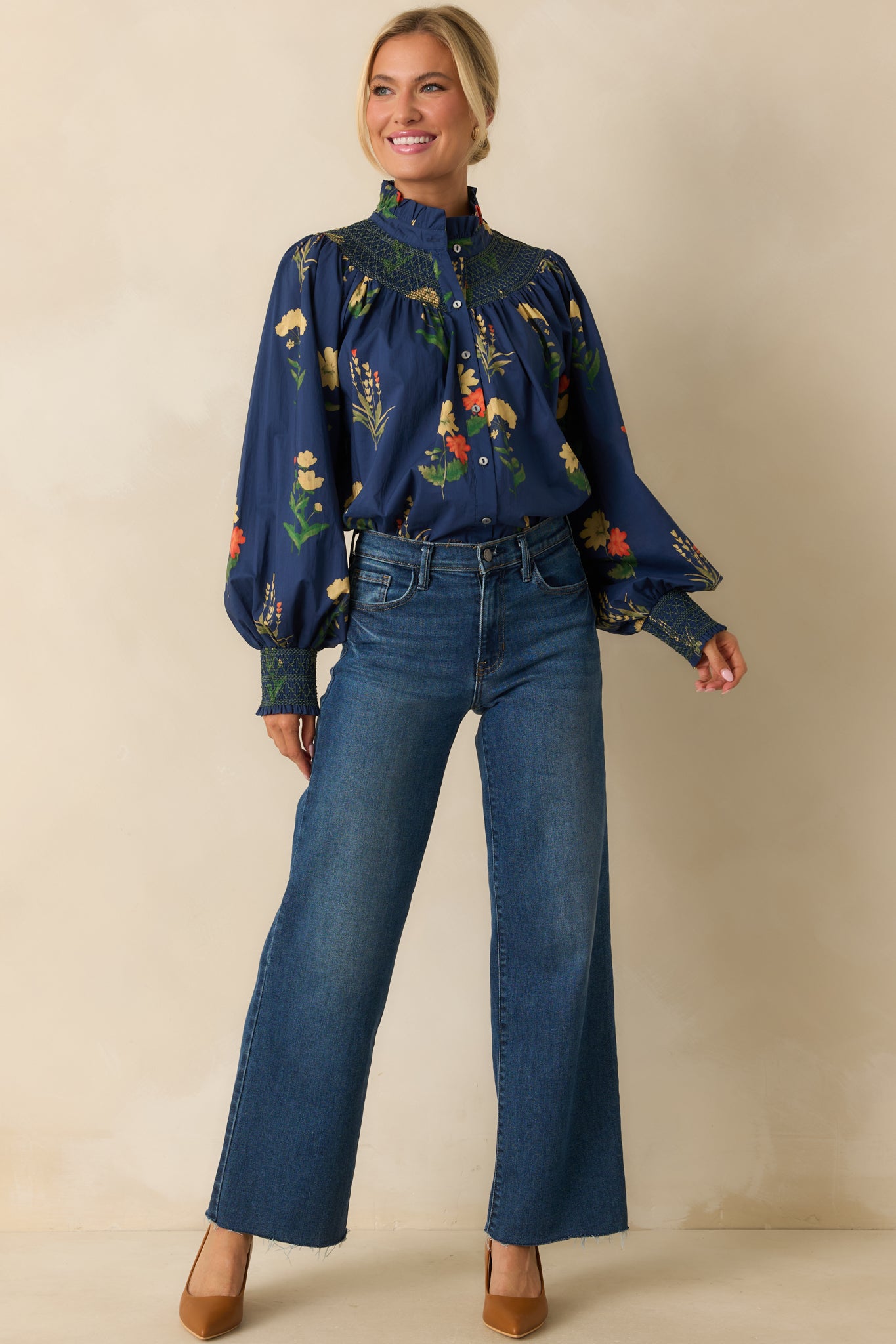 Front view highlighting the feminine ruffled collar and relaxed silhouette of the navy blouse.
