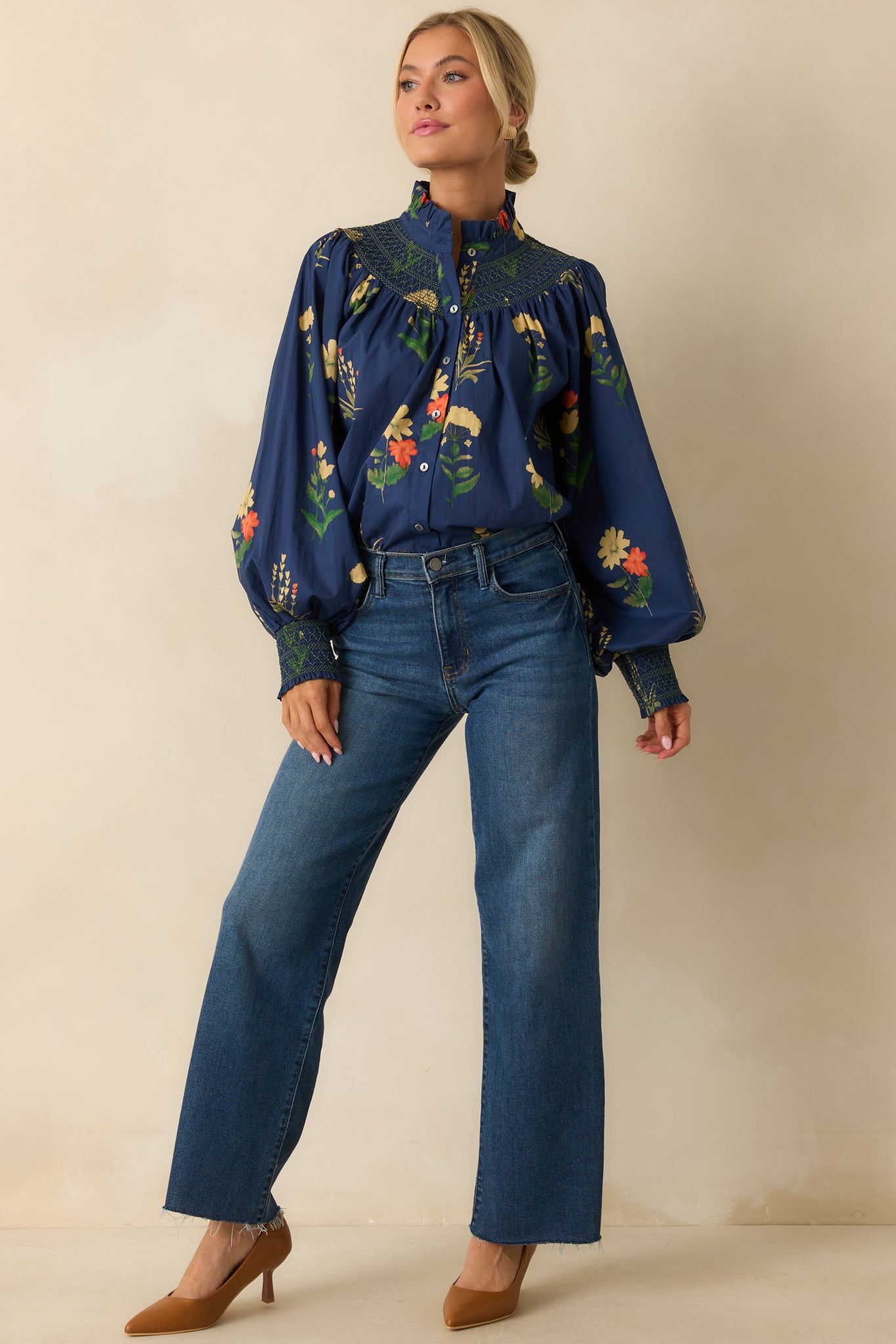 Woven floral blouse showing the smocked cuffs and smooth drape of the fabric.