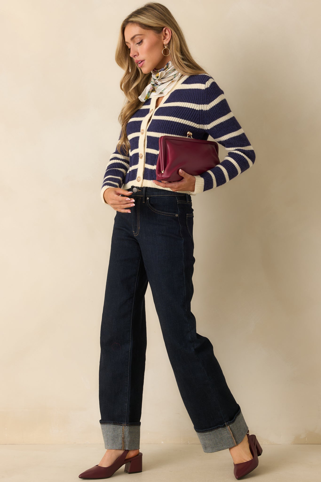 Front-facing navy striped cardigan featuring patch pockets and a neat cropped silhouette.