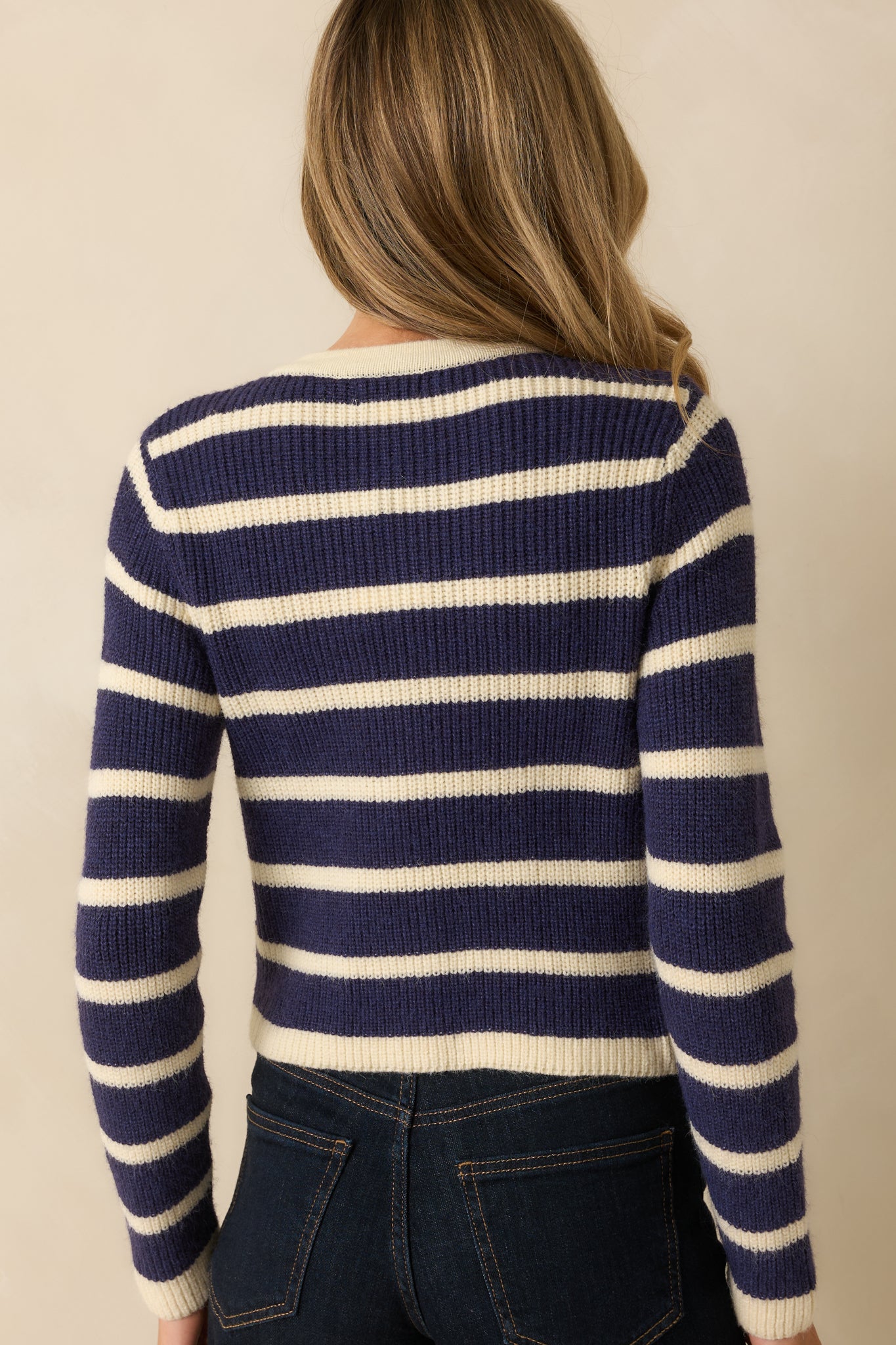 Rear view of the navy stripe cardigan showing the even stripe pattern and clean cropped hemline.