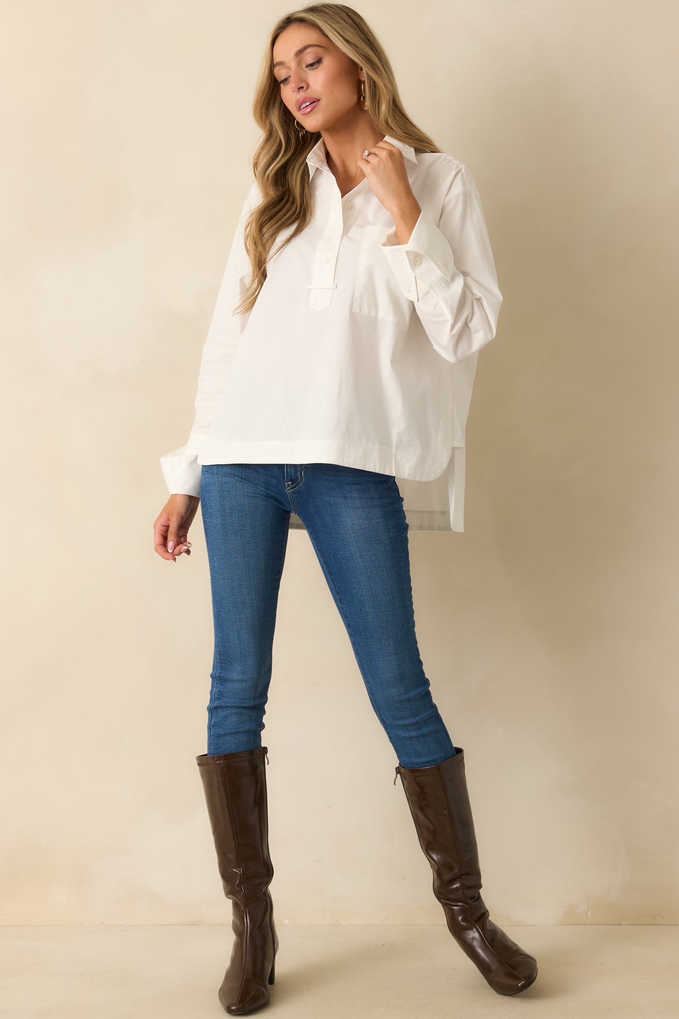 White woven cotton blouse styled front-facing to highlight the relaxed fit, straight hem, and collared neckline.