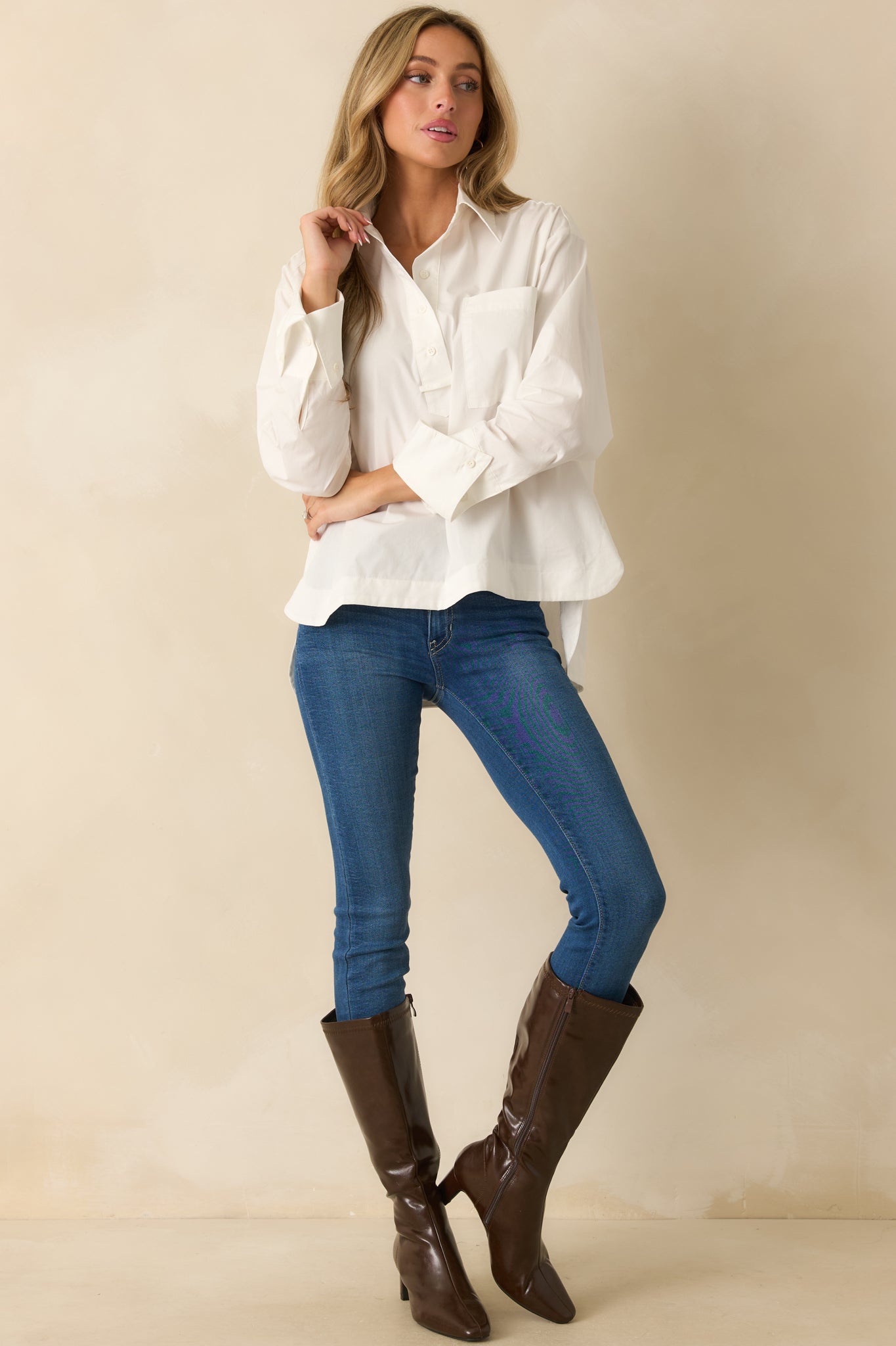 Front view highlighting the single patch pocket and relaxed silhouette of the white blouse.