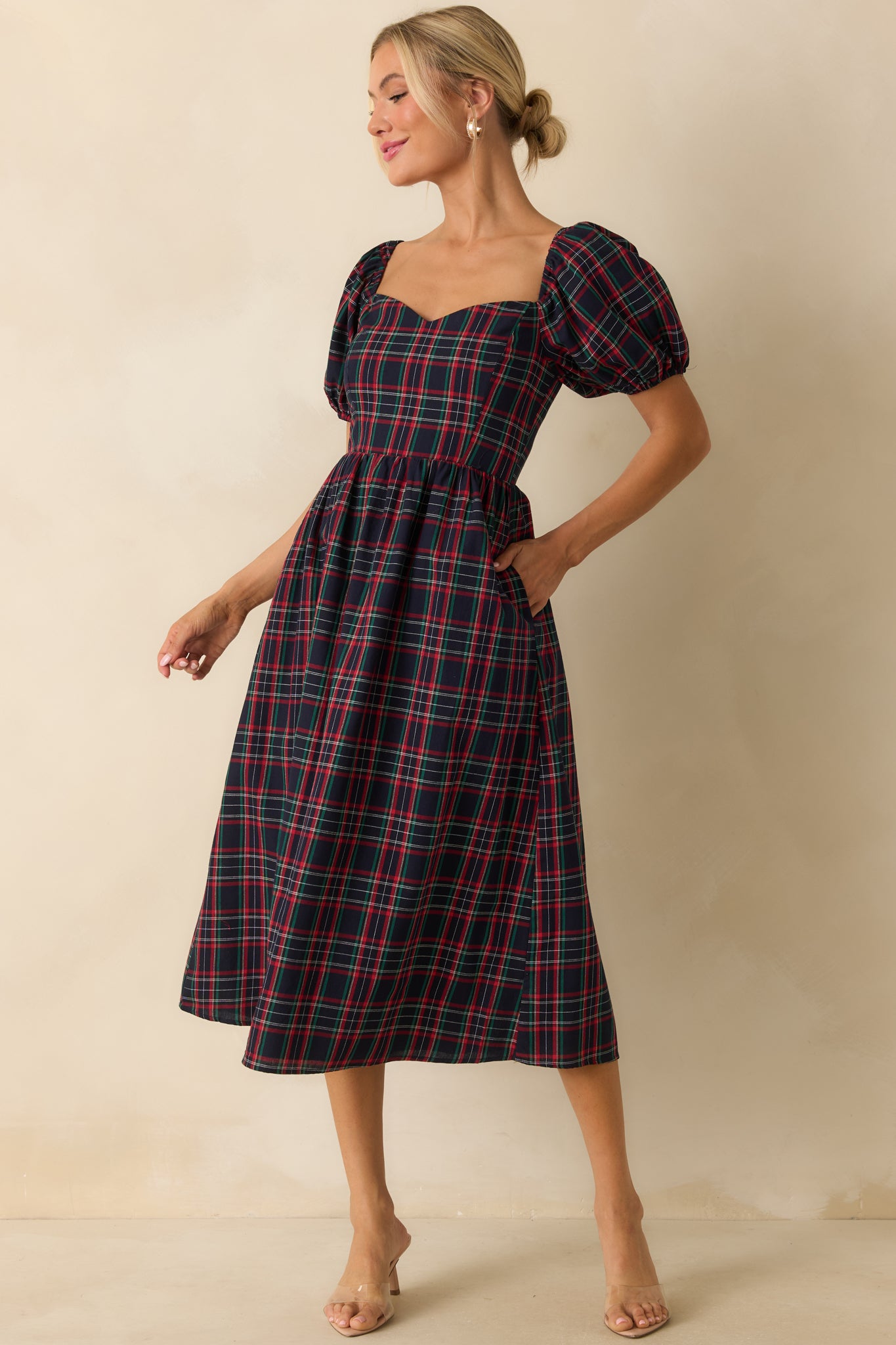 Navy plaid dress with a sweetheart neckline, short puff sleeves, and fitted front bodice.
