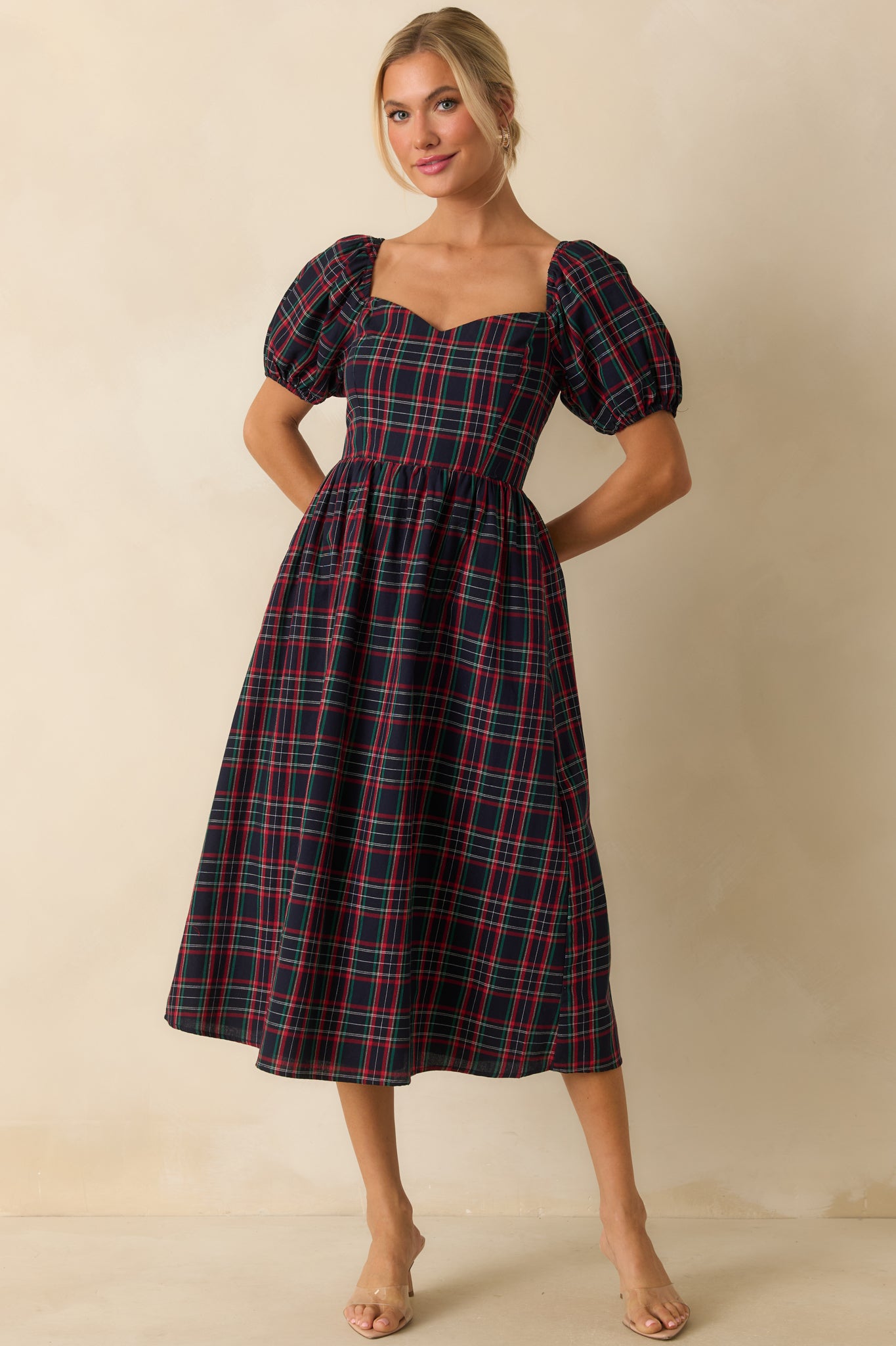 Slim-fit navy plaid dress with puffed sleeves and a classic front shape.
