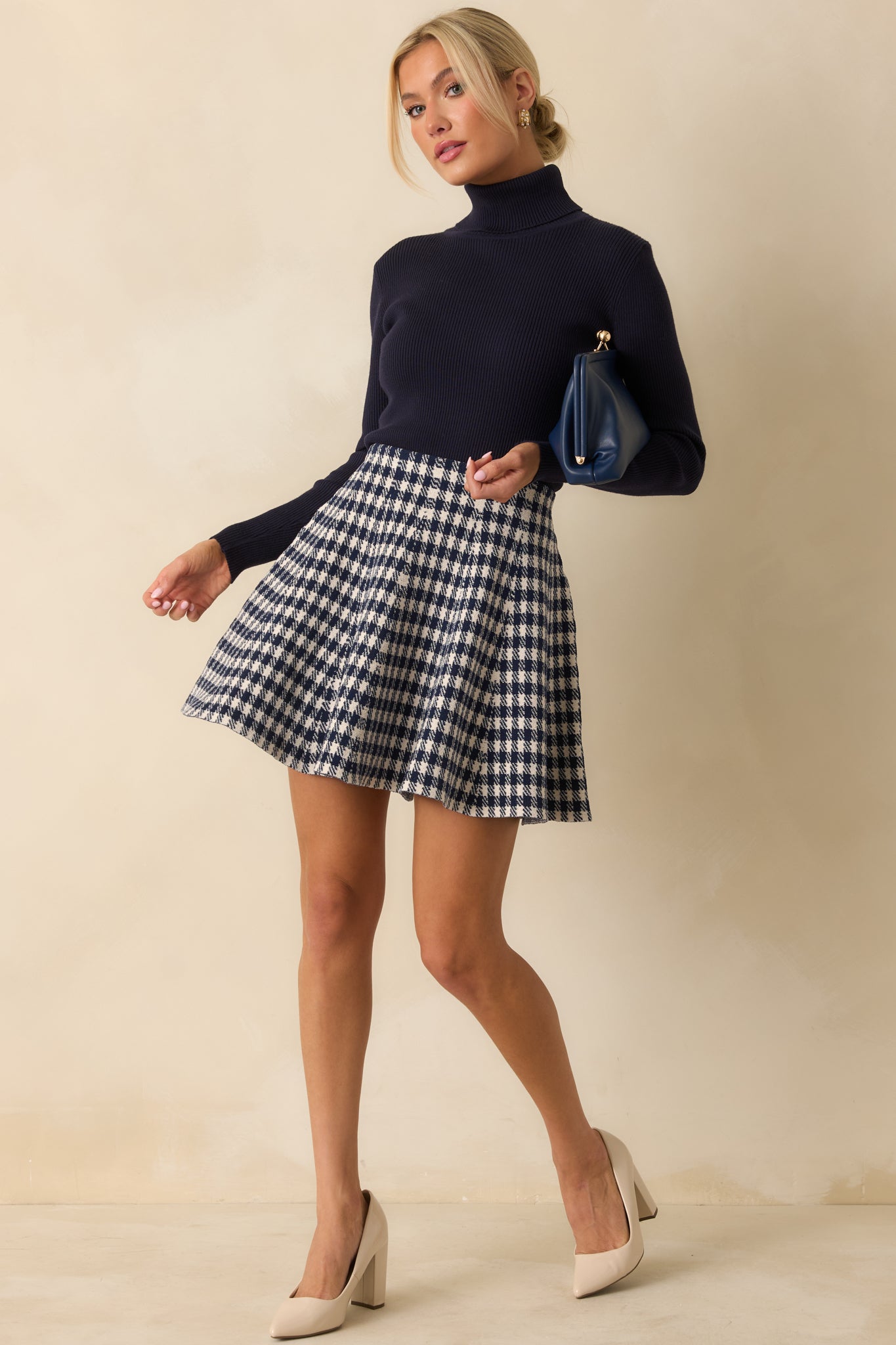 Fitted ribbed sweater in deep navy with a classic turtleneck design.