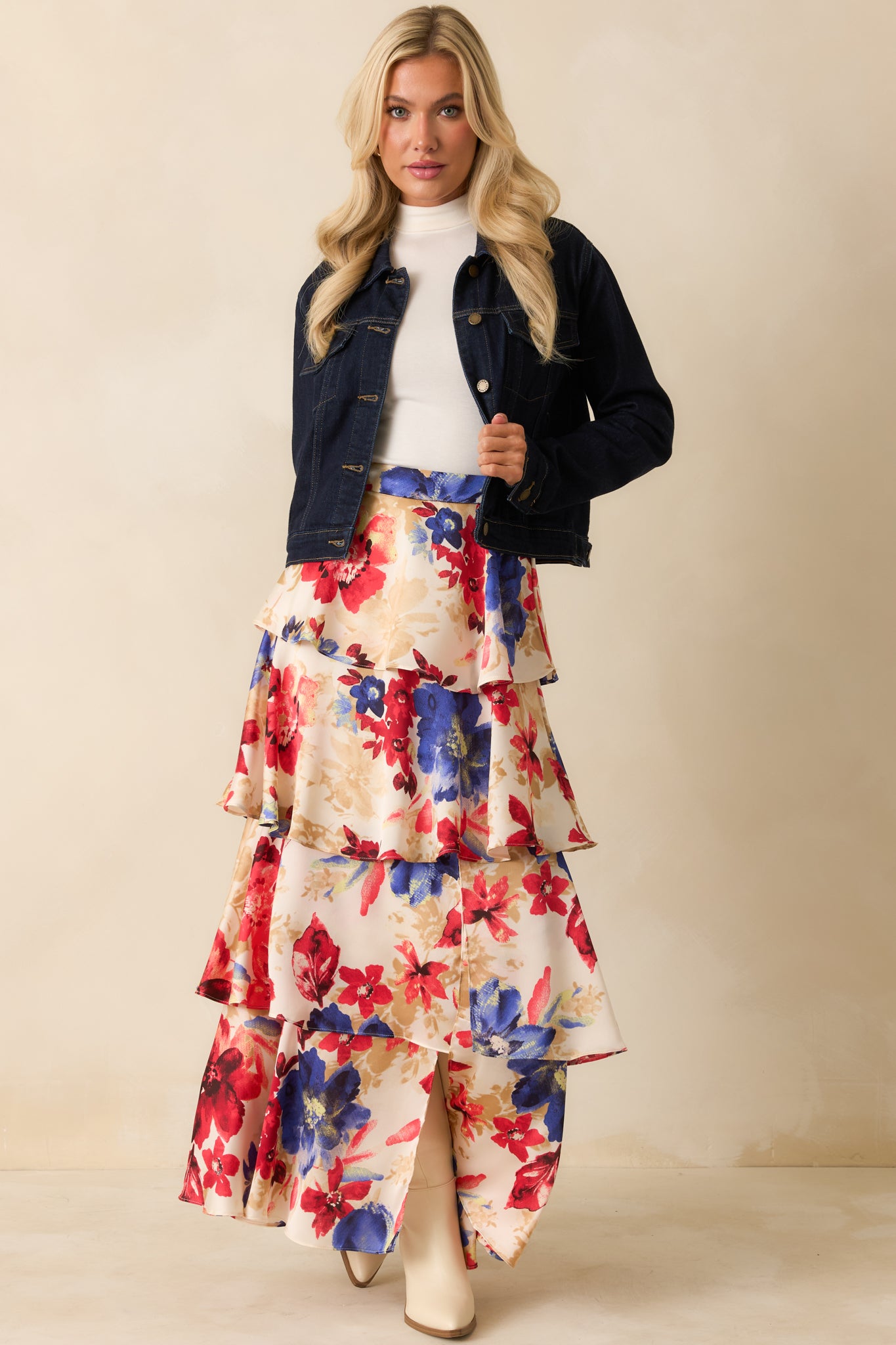 Structured dark denim jacket showcasing long sleeves with button cuffs and a timeless silhouette.