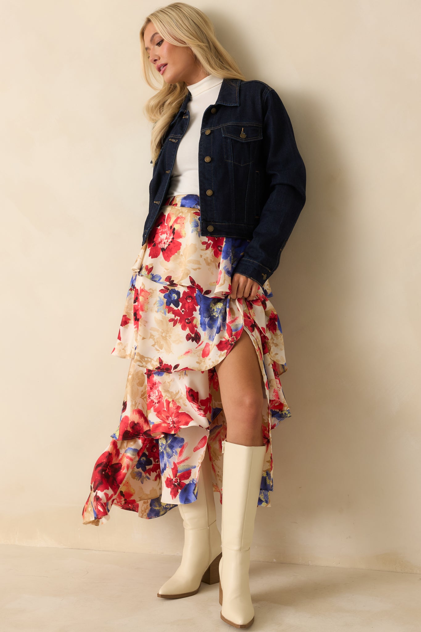 Dark wash denim jacket styled with a classic collared neckline and contrast stitching throughout.