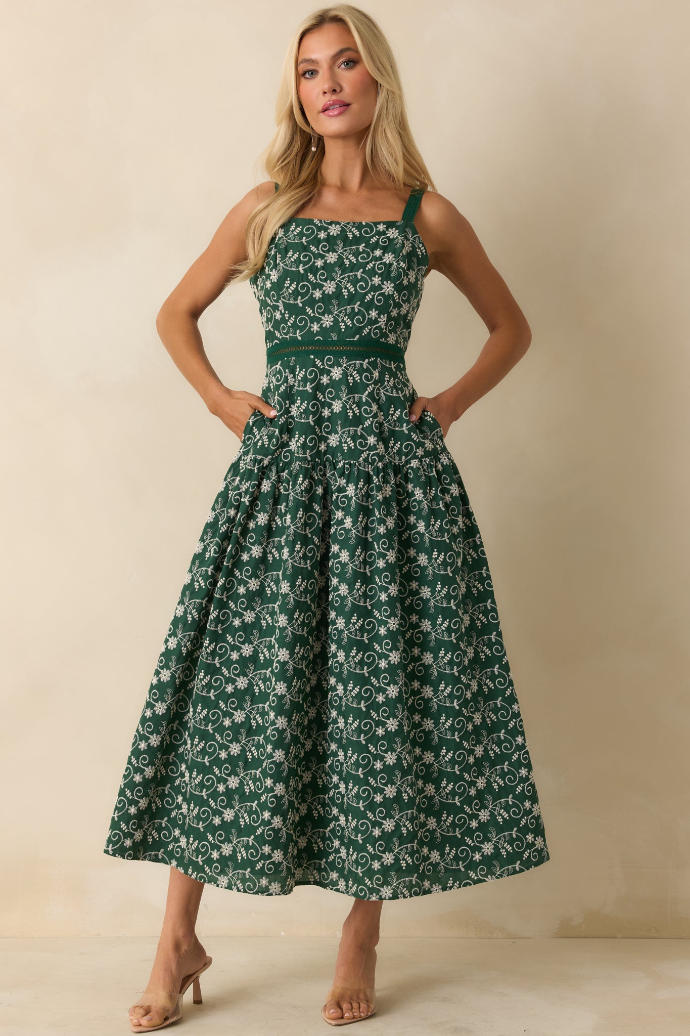 Front view of hunter green maxi dress with flowing skirt, adjustable straps, square neckline, and subtle waist detailing.