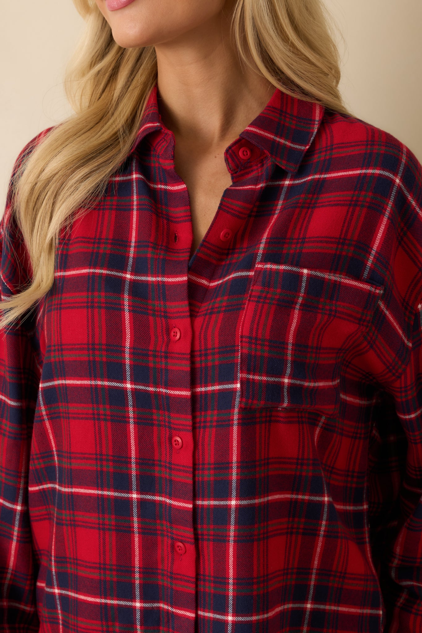 Buttery soft flannel fabric in red plaid, highlighting the button-front closure and smooth woven texture.