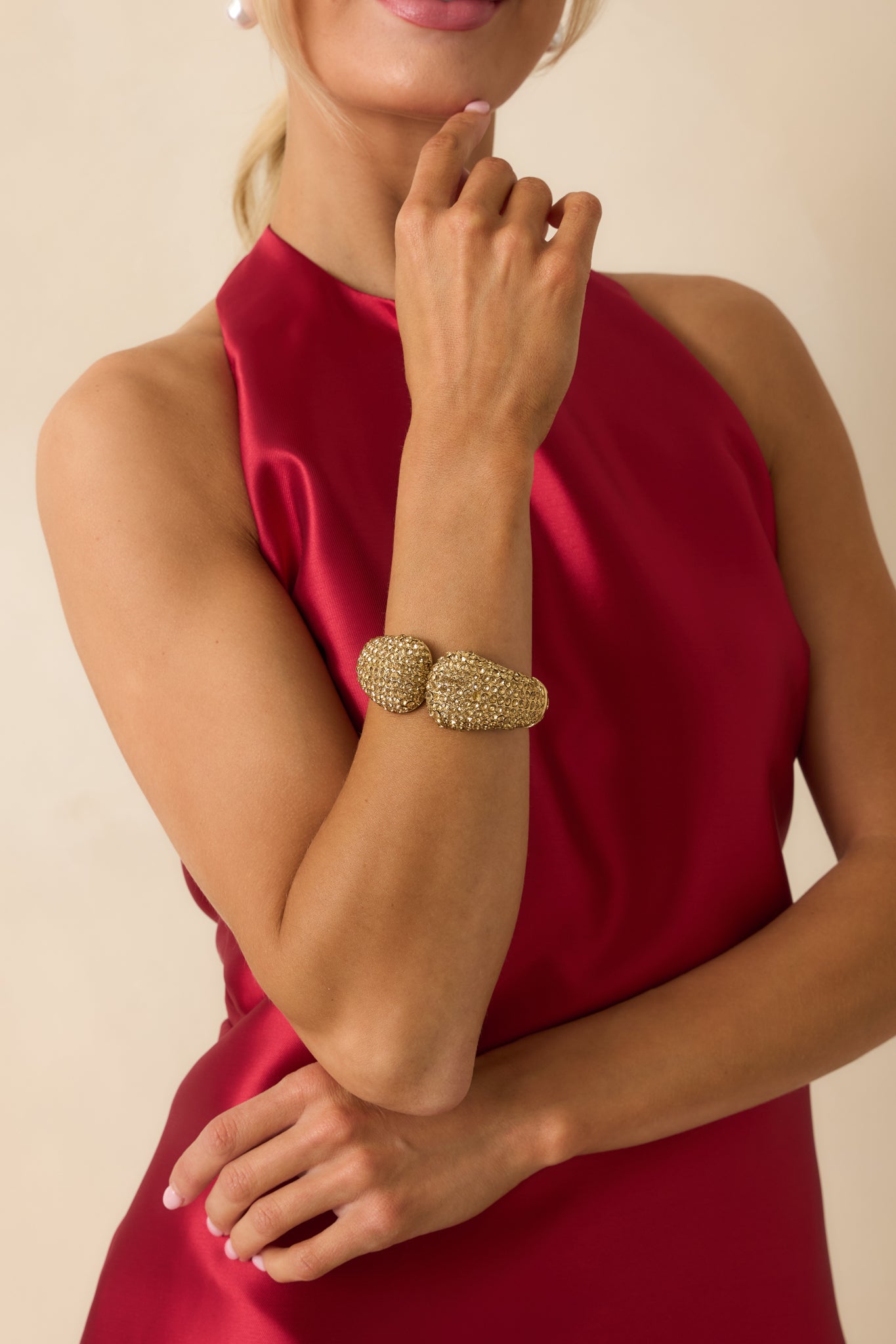 Gold cuff bracelet featuring sparkling gold rhinestones across the top half and smooth rounded edges.