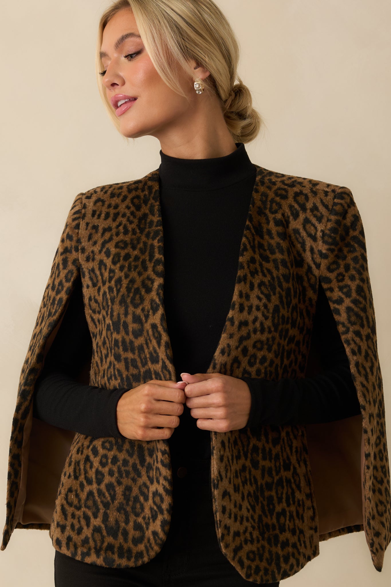 Cropped focus on the straight hem and subtle fuzzy finish of the polyester-wool blend.