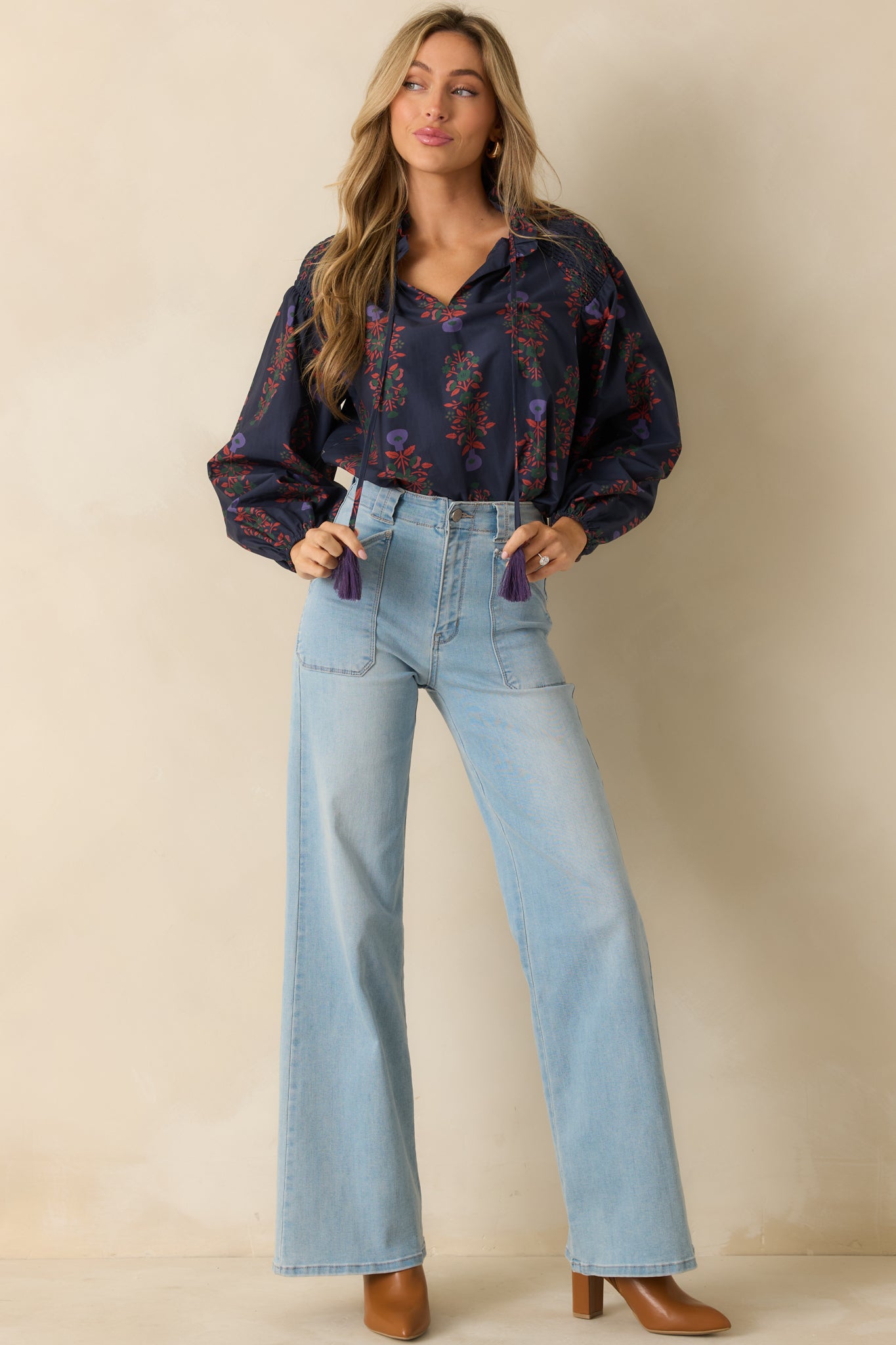 Floral-print peasant top in navy with a loose shape and subtle gathers at the shoulders.