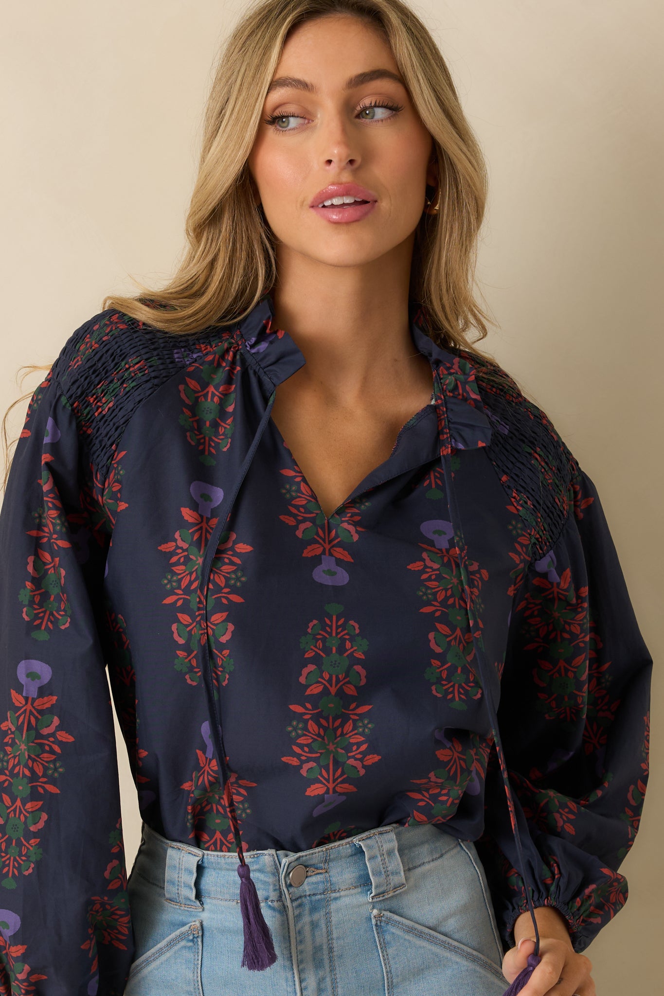 Navy floral top highlighting the split neckline, optional front ties, and airy long sleeves.